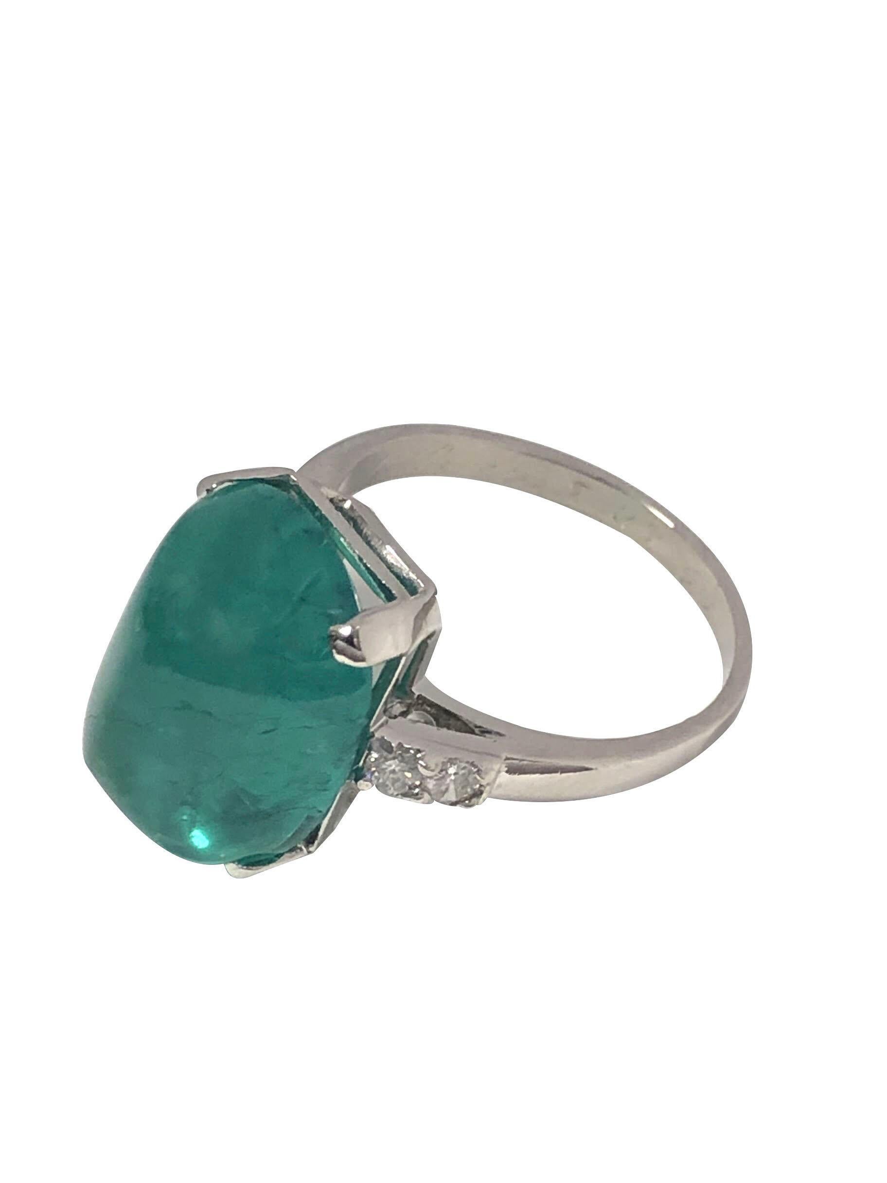 Circa 1940 Platinum Ladies Ring, Centrally set with a G.I.A Certified 10.81 Carats Sugarloaf Emerald of Russian origin, Very Fine Transparent Green in color and Having Moderate F2 Clarity enhancement treatment. Set in a Platinum Mounting with Basket