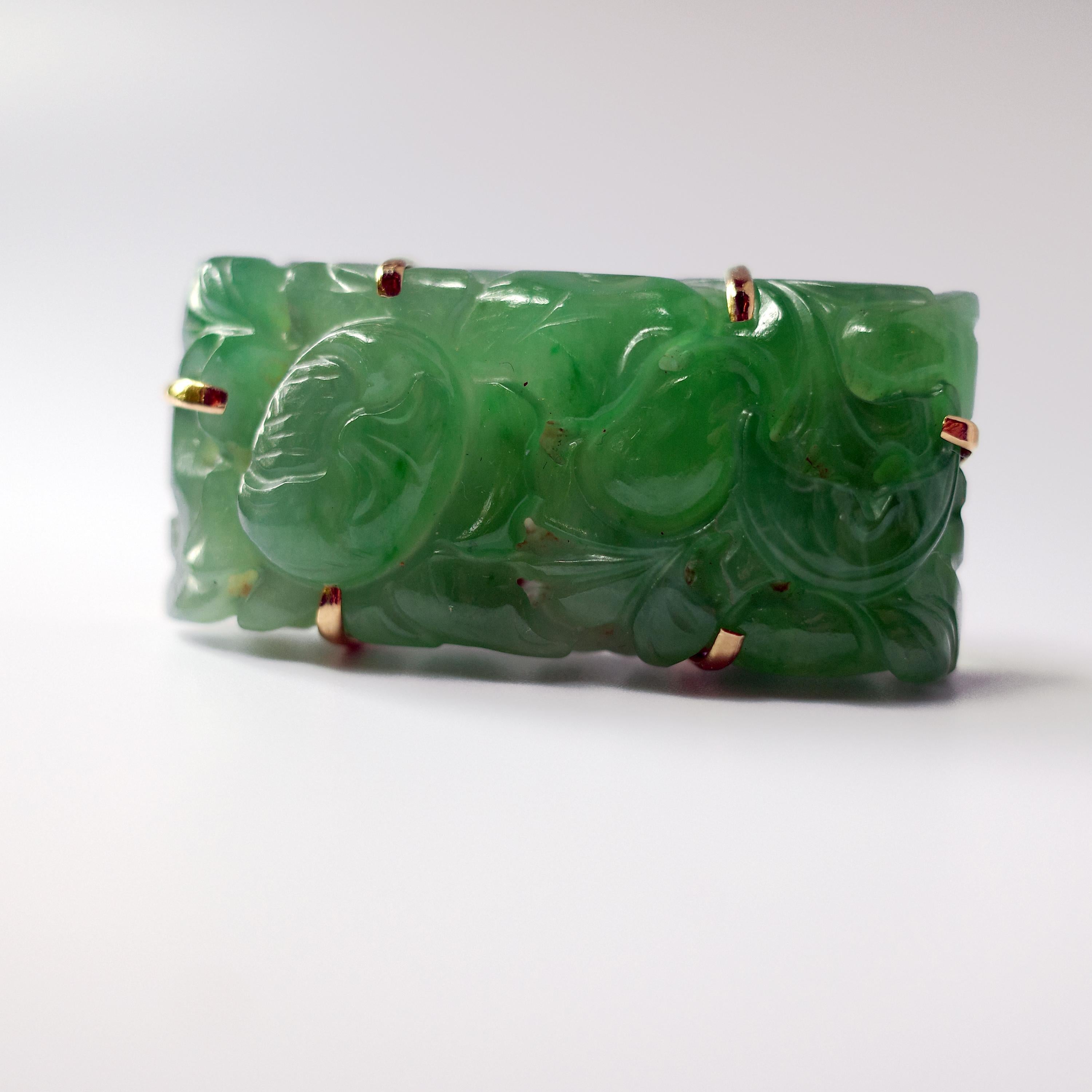 Featuring a light apple green jadeite jade stone carved in a floral motif and set within a beautifully designed 14K rose gold framework, this Art Deco period brooch is quite the stunning rectangle of color, translucency and spring-green. Check out