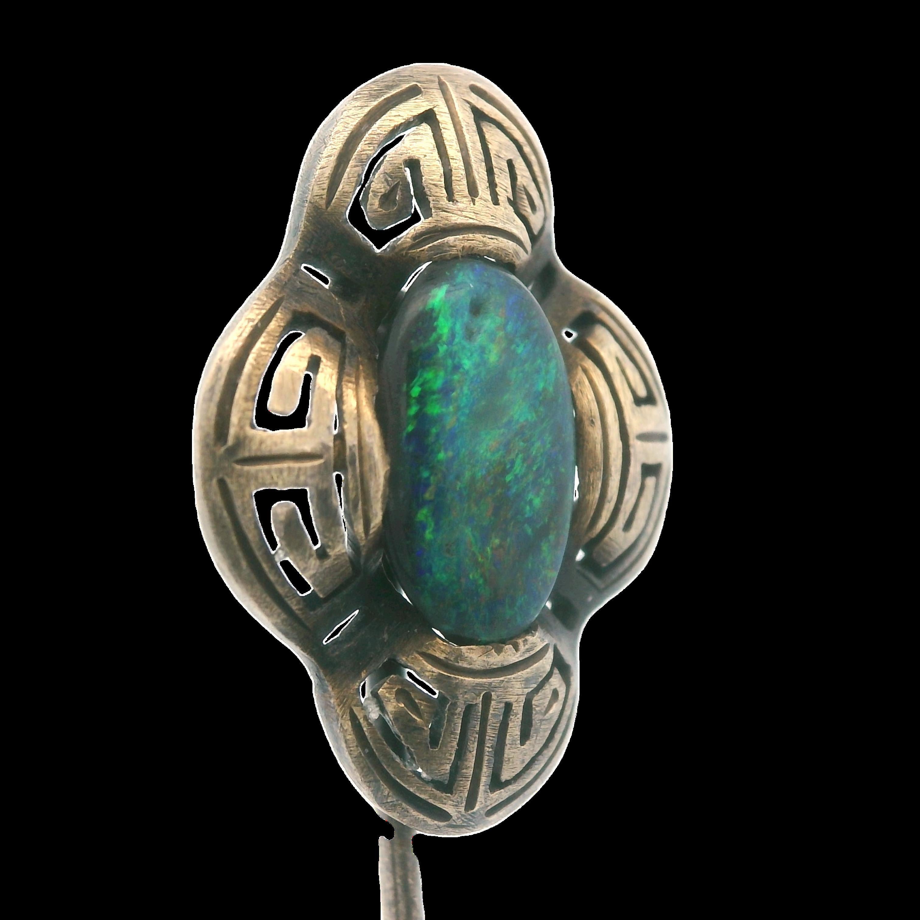 This gorgeous stick pin comes from the Art Deco period(1925) and is made in 14k yellow gold with a natural, un-treated, black opal center. The natural black opal is a .60 carat cabochon cut opal, with bright streaks of red(very rare) and green, that