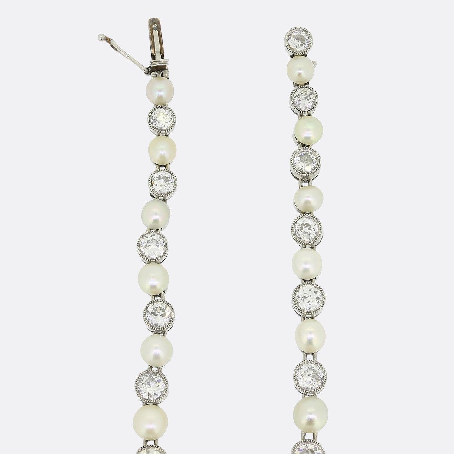 Here we have an Art Deco diamond and pearl bracelet. Set in platinum, it features an alternating sequence of drilled natural pearls and milgrain set old cut diamonds that graduate in size to the centre. This is a rare and excellently crafted piece