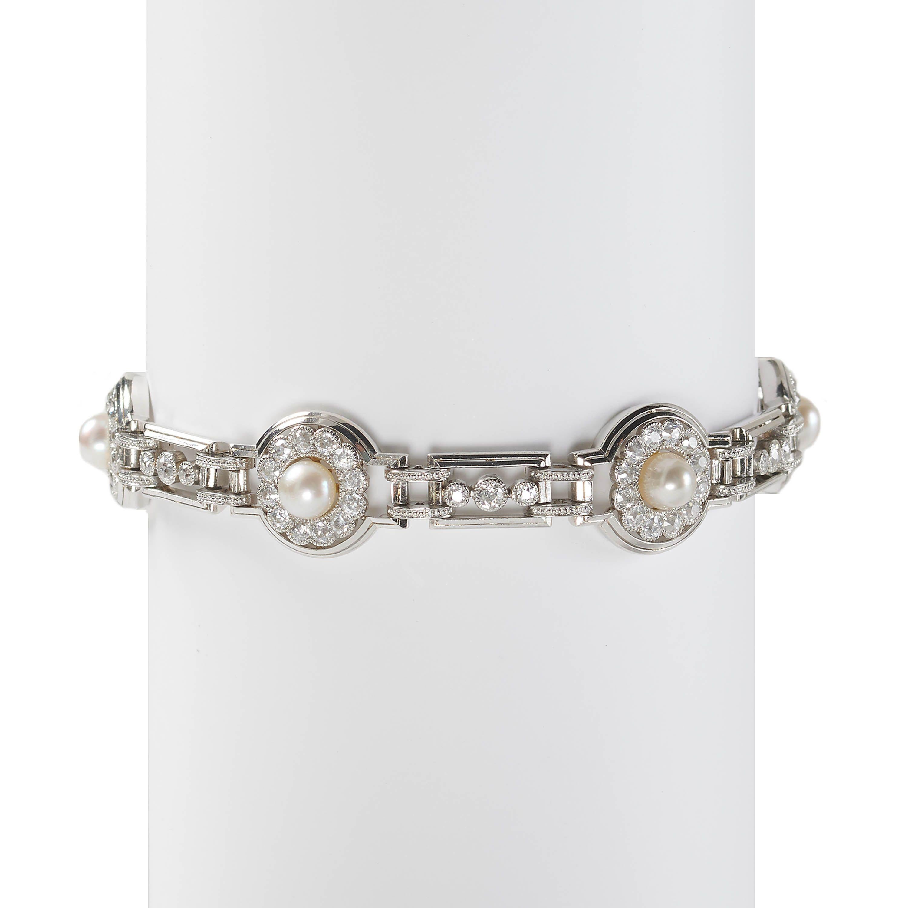 An Art Deco natural pearl, diamond and platinum bracelet, of an alternating circle and rectangle design, with six, graduating, two row platinum rings, each with clusters, set with natural, bouton pearls, on gold backed settings, in the centre of