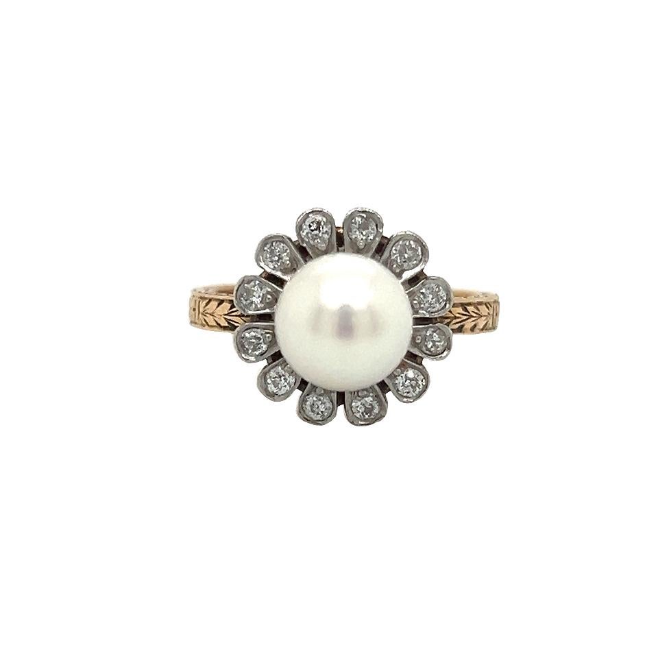 Beautiful details seen on this Art Deco treasure. The ring highlights one natural pearl gemstone that is accented with a daisy flower shaped halo set with all old mine cut diamonds.  The pearl shows a beautiful rich luster and the scintillation from