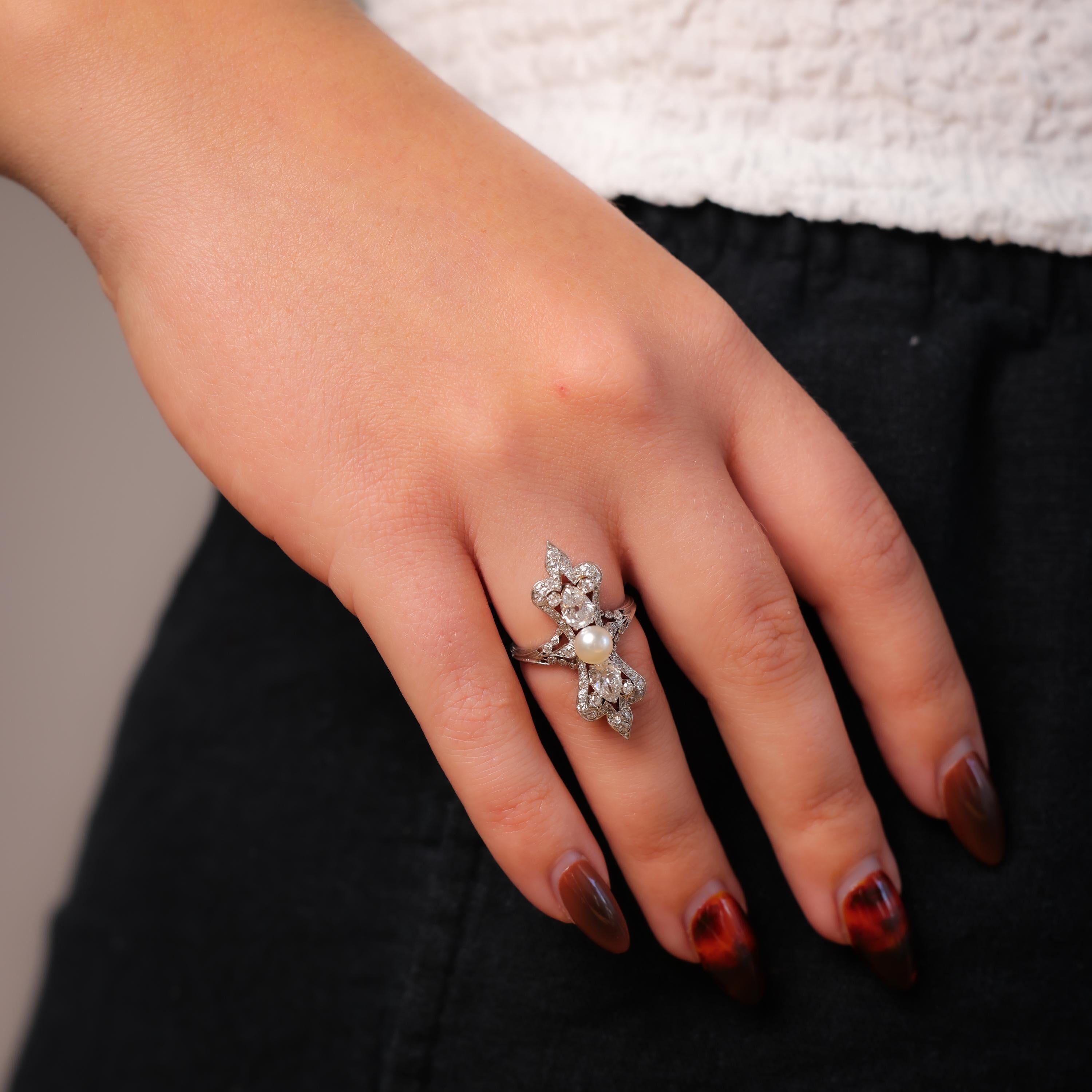 This exquisite Art Deco cocktail ring in platinum showcases a lustrous natural saltwater pearl encircled by dazzling diamonds. A timeless embodiment of vintage elegance.

Center stone: Natural salt water pearl
Size: Approximately 5.58mm
Accent