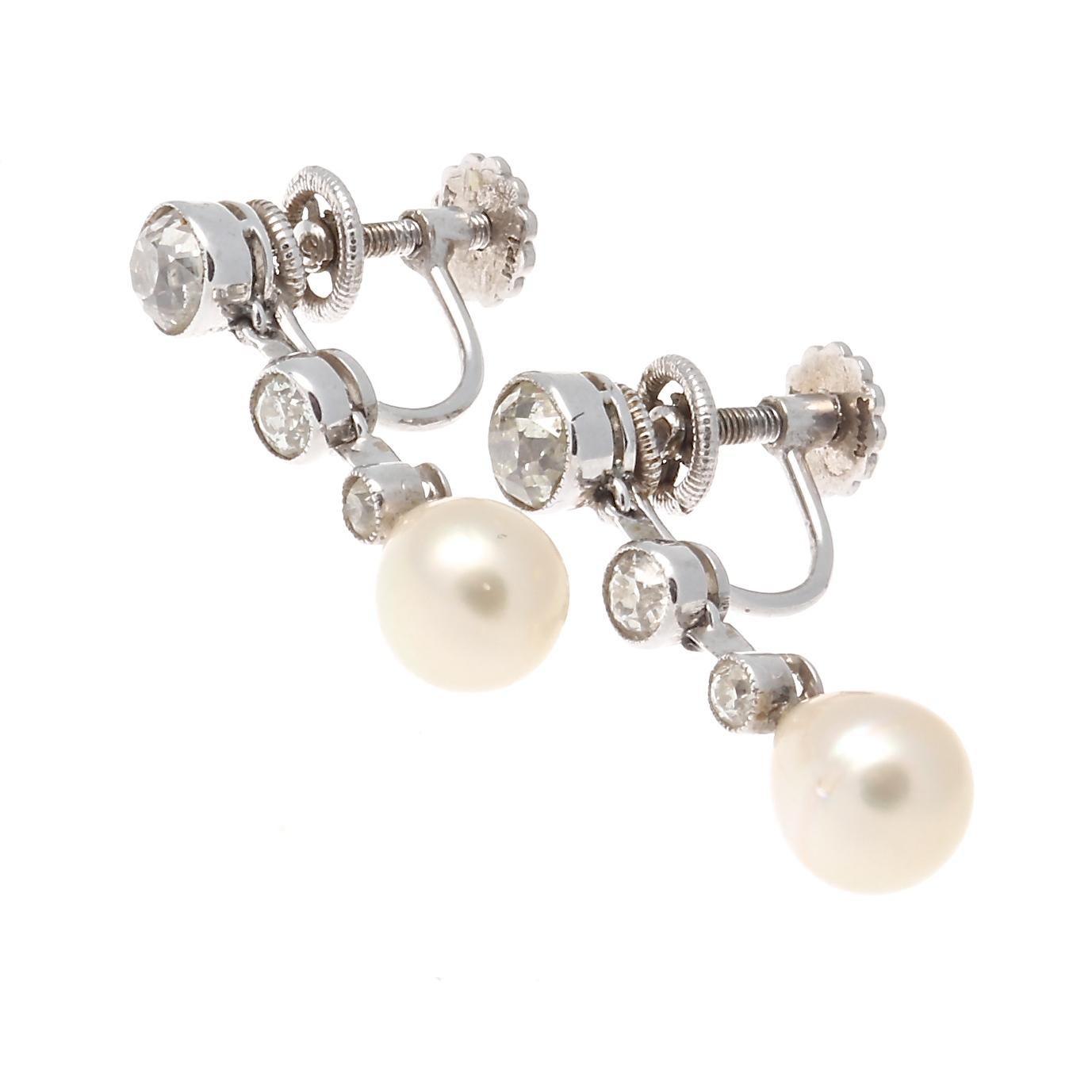 Classic Art deco earrings that are still relevant today. Featuring GIA certified cream color natural salt water pearls hanging from a strand of near colorless old cut diamond. Hand crafted in platinum. 1 inch long.