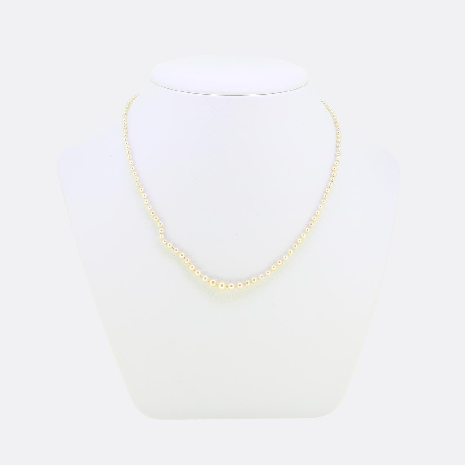 Here we have a gorgeous natural pearl necklace crafted during the pinnacle of the Art Deco movement. This piece consists of a single row of individually knotted round shaped natural saltwater pearls. All stones used here collectively graduate in