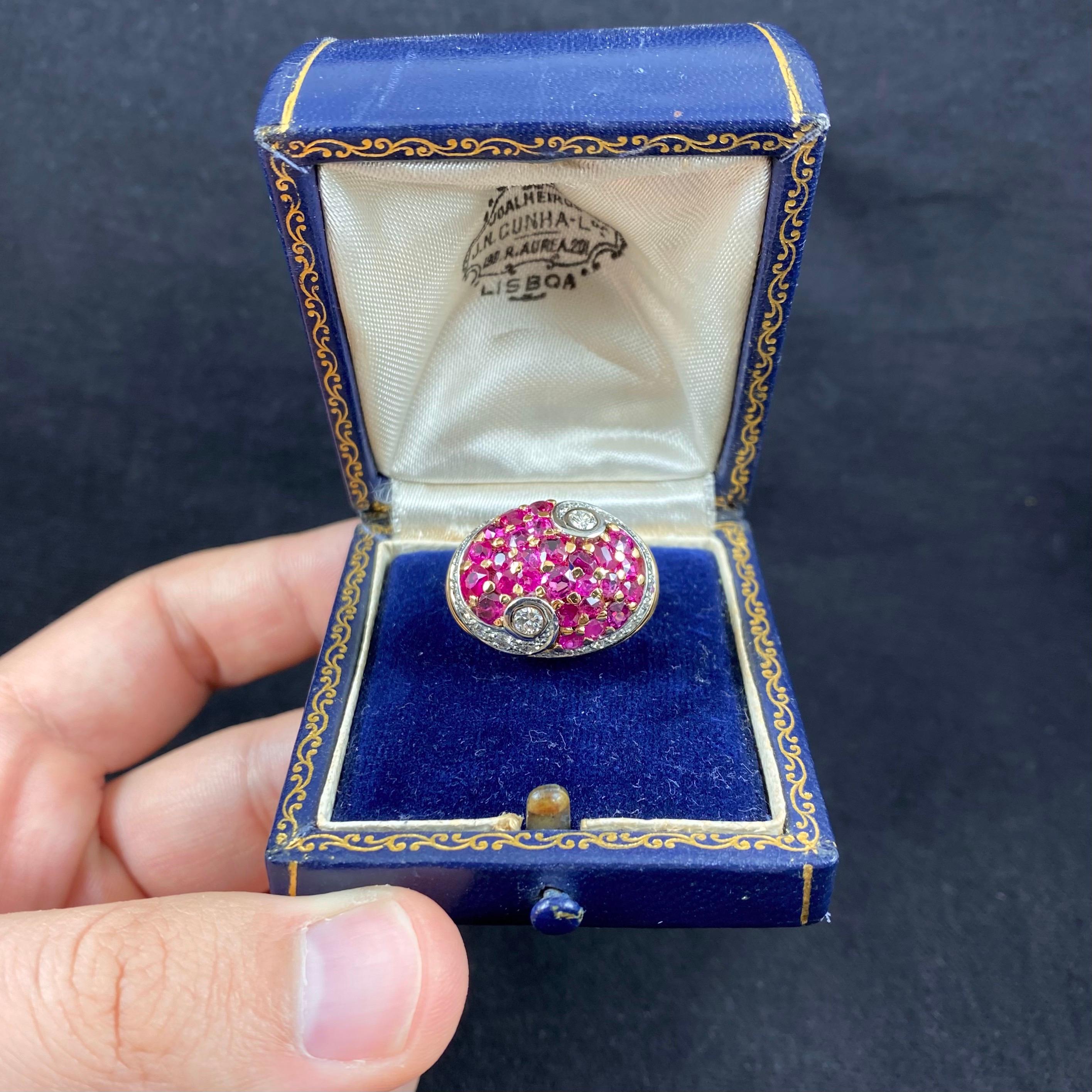 Art Deco natural unheated ruby and diamond bombe cocktail ring in rose gold and platinum, European, 1930s/1940s. This spectacular dress ring of a bombe domed design is pave-set with 26 natural unheated cherry-colored rubies surrounded by a stylized