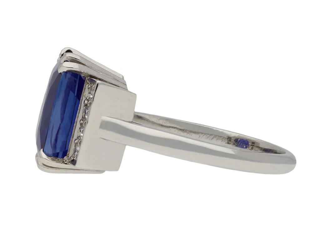 Art Deco Ceylon sapphire and diamond ring. Centrally set with a cushion shape old cut natural unenhanced Ceylon sapphire in an open back claw setting with an approximate weight of 5.45 carats, flanked by eight round eight-cut diamonds in open back