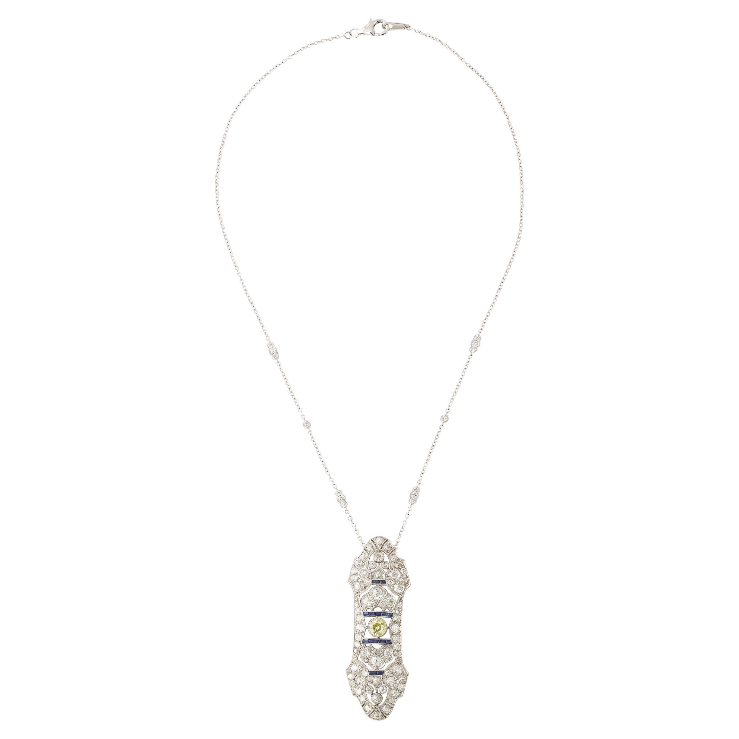 This beautiful Art Deco Pendant Necklace was created in America Circa 1925. Featuring a Shield form silhouette, the line work beautifully balances gentle curves and angular moments reminiscent of the framing of stained glass windows. A beautiful