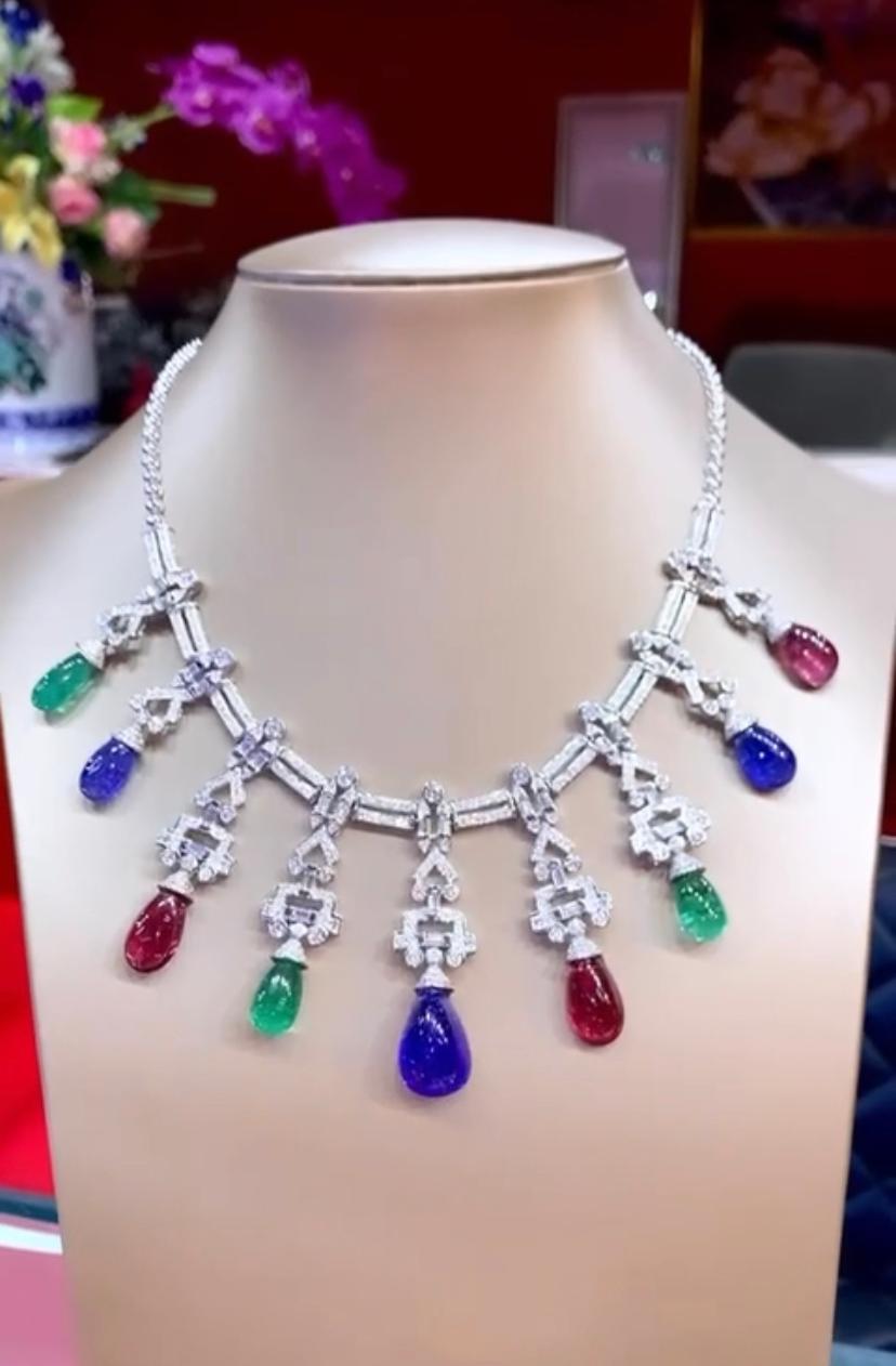 An exquisite Art Deco design necklace, so chic and refined, a very piece of art , in 18k gold , featuring  3 large Drop Zambian Emeralds  of 24.18 cts , 3 pcs Drop Rubellite Tourmalines of 
26.57 cts, and 3 Drop Tanzanites of 43.65 cts. All fully