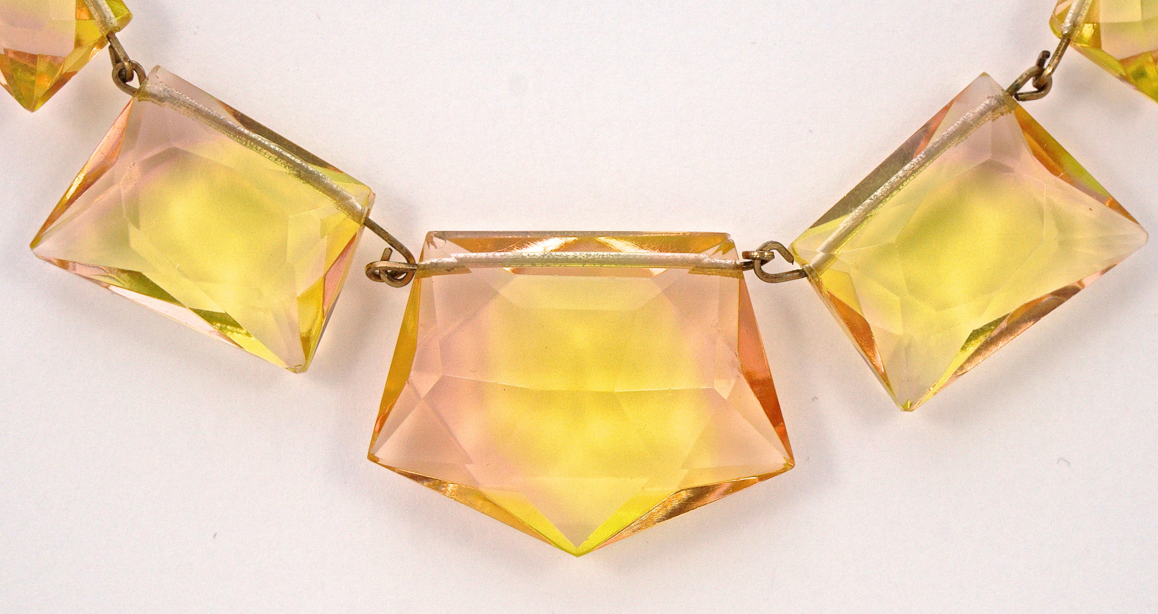 Art Deco gold tone necklace featuring fabulous shell pink and light yellow faceted uranium glass beads. Length 42cm / 16.53 inches, and the largest glass bead measures maximum width 3.5cm / 1.37 inches by 2.7cm / 1.06 inches. There is a chip to one