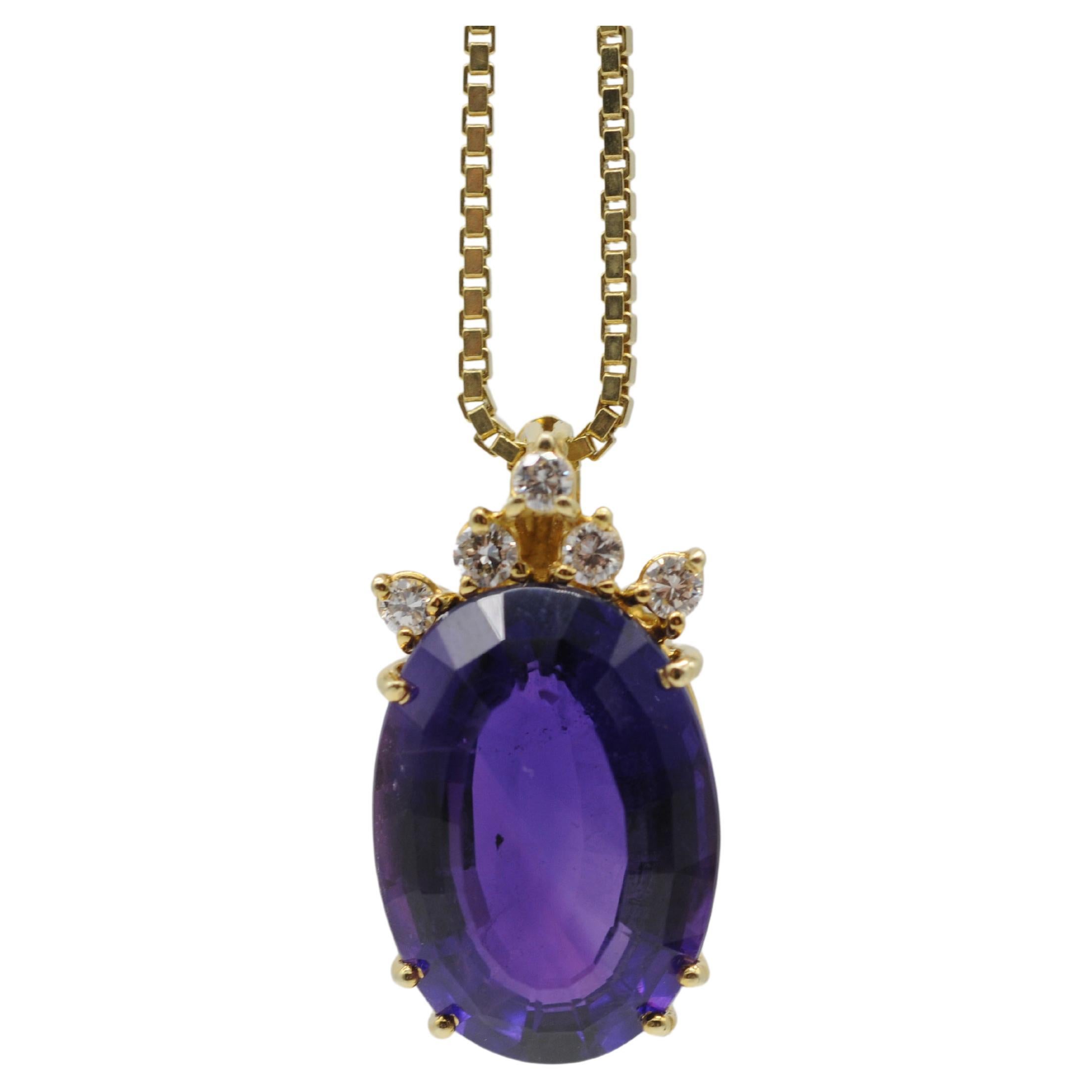 Immerse yourself in the enchanting beauty of this 14k yellow gold necklace featuring a magnificent pendant. The opulent centerpiece of this necklace is a stunning large amethyst, skillfully cut in an oval shape with a step-cut that bears a striking