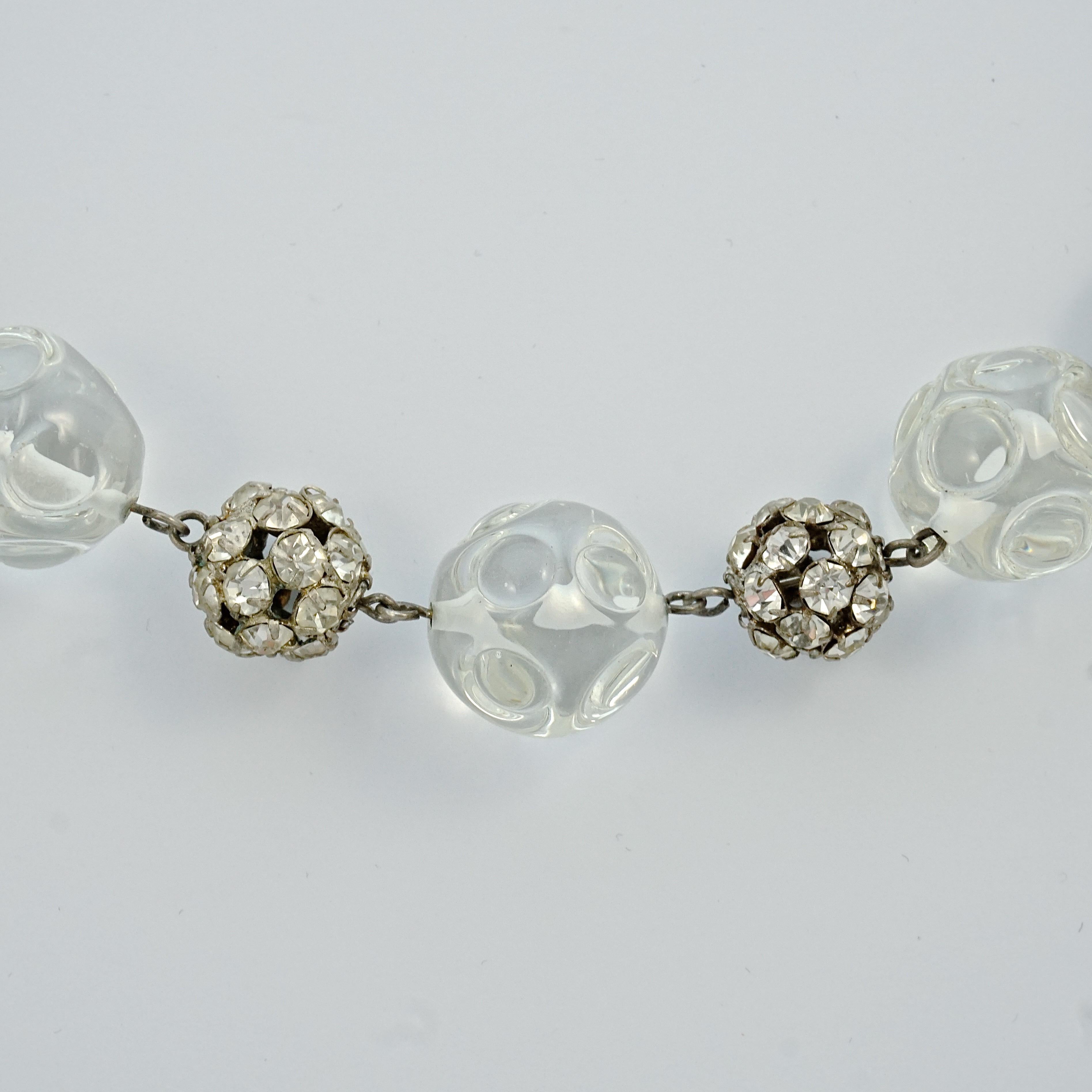 Fabulous Art Deco silver tone necklace featuring clear glass ball beads with an embossed circle design, and rhinestone balls. Length 43.7cm / 17.2 inches, and the clear glass beads are 1.8cm / .7 inches. The necklace is in very good condition.

This