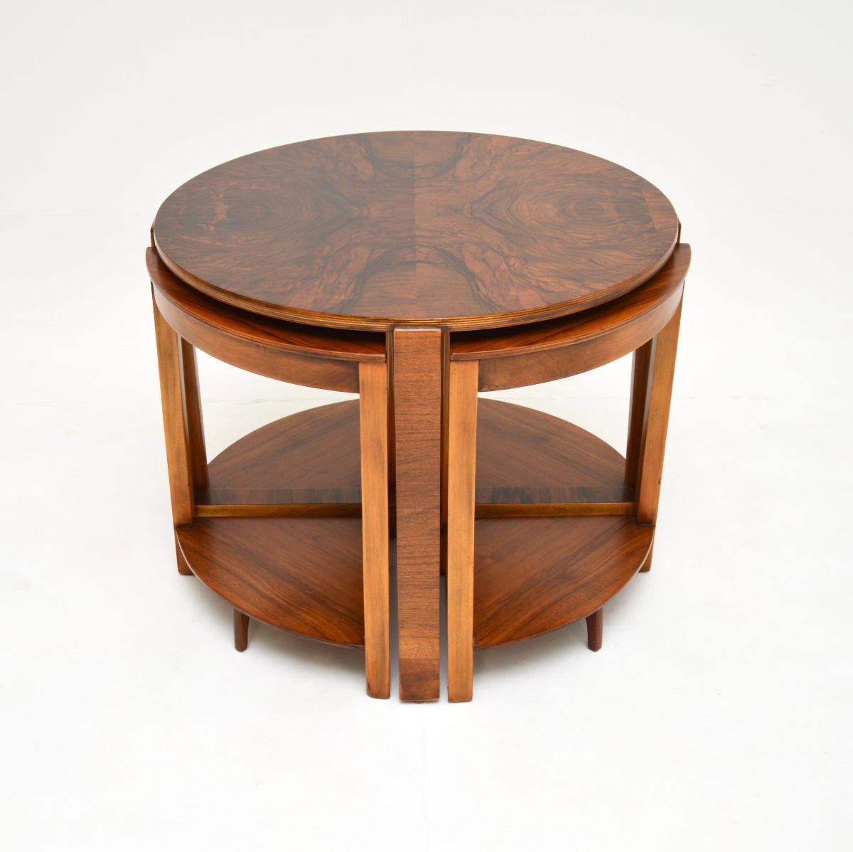 A stylish and extremely well made Art Deco nesting coffee table in walnut. This was made in England, it dates from the 1930’s.

The quality is outstanding, this has a gorgeous design and is very practical. The four smaller pie shaped tables nest