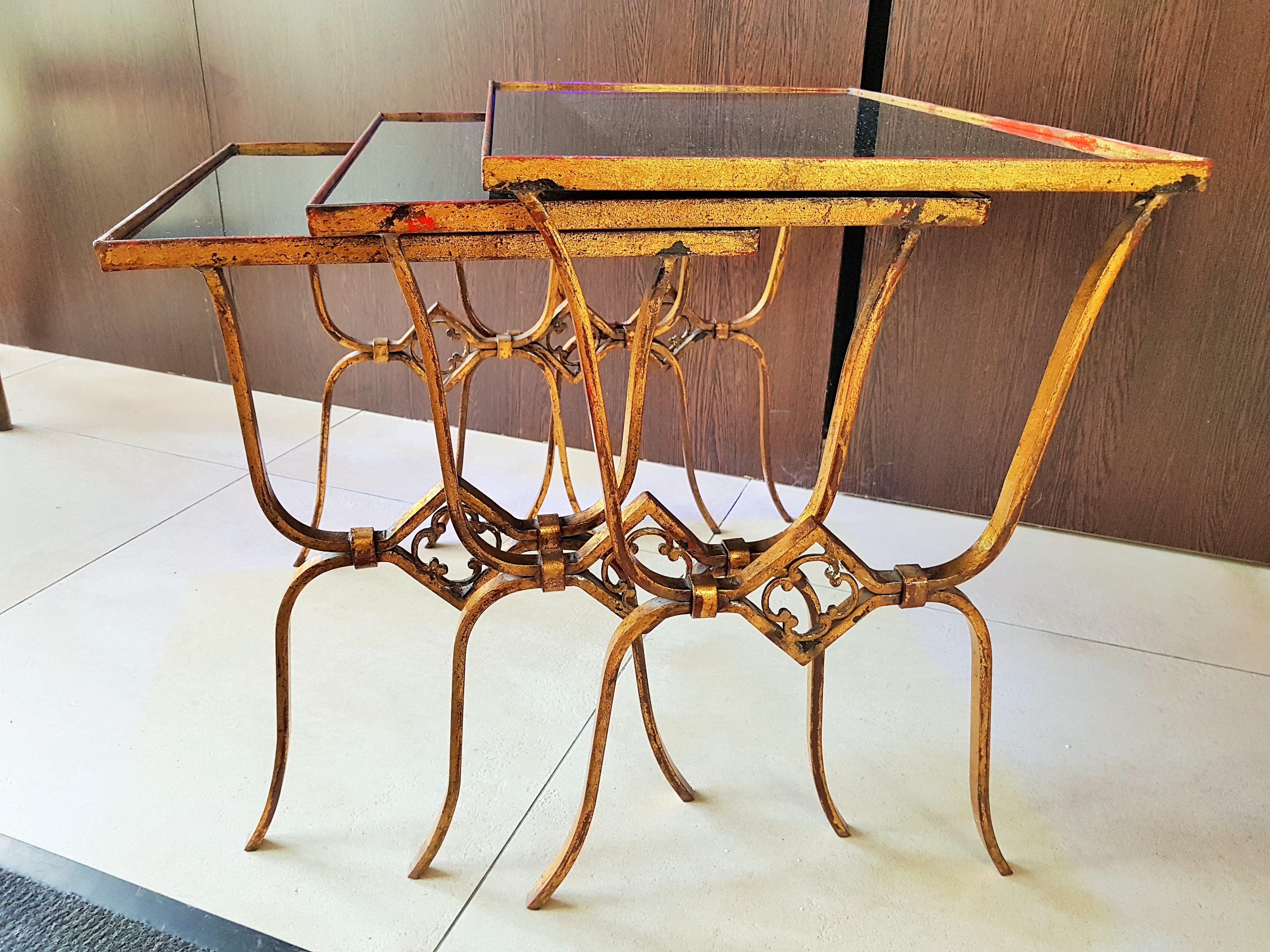 Art Deco nesting tables gold leaf, France 1940s.
nice patinated.

black glass tops.