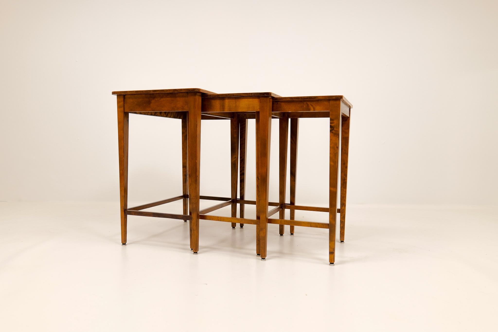These nesting tables was produced in Sweden during the 1940s. They where produced at Nordiska Kompaniets (NK) factorys, and they only prodcued high uality pieces. The tables are beautiful done with mahognay veneer and nicely framed with Stained