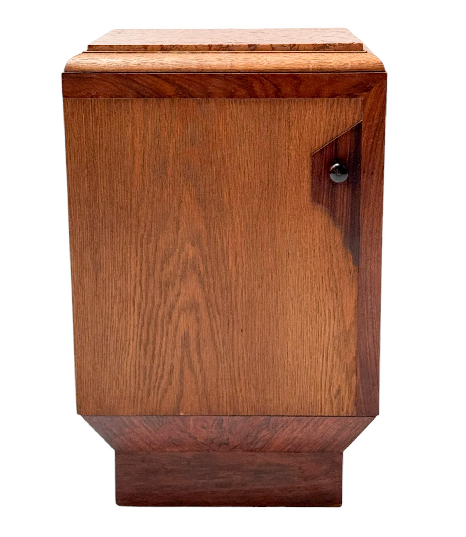 Stunning and rare Art Deco nightstand or bedside table.
Striking Dutch design from the 1930s.
Solid oak and original oak veneer base with original colored marble top.
Original solid macassar ebony knob.
This wonderful Art Deco nightstand or bedside