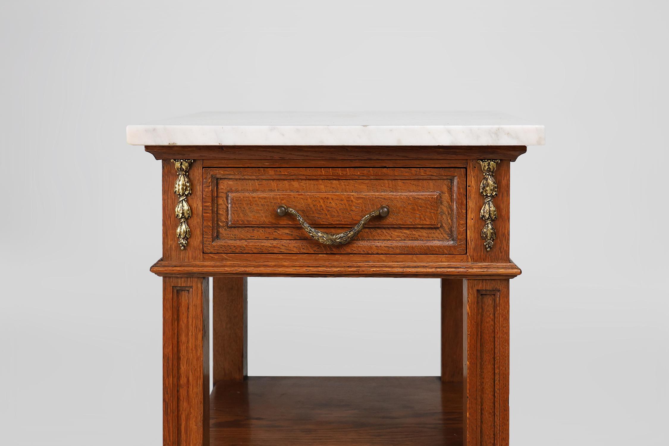 Carved Art Deco nightstand with a Carrara marble top, France ca. 1910 For Sale