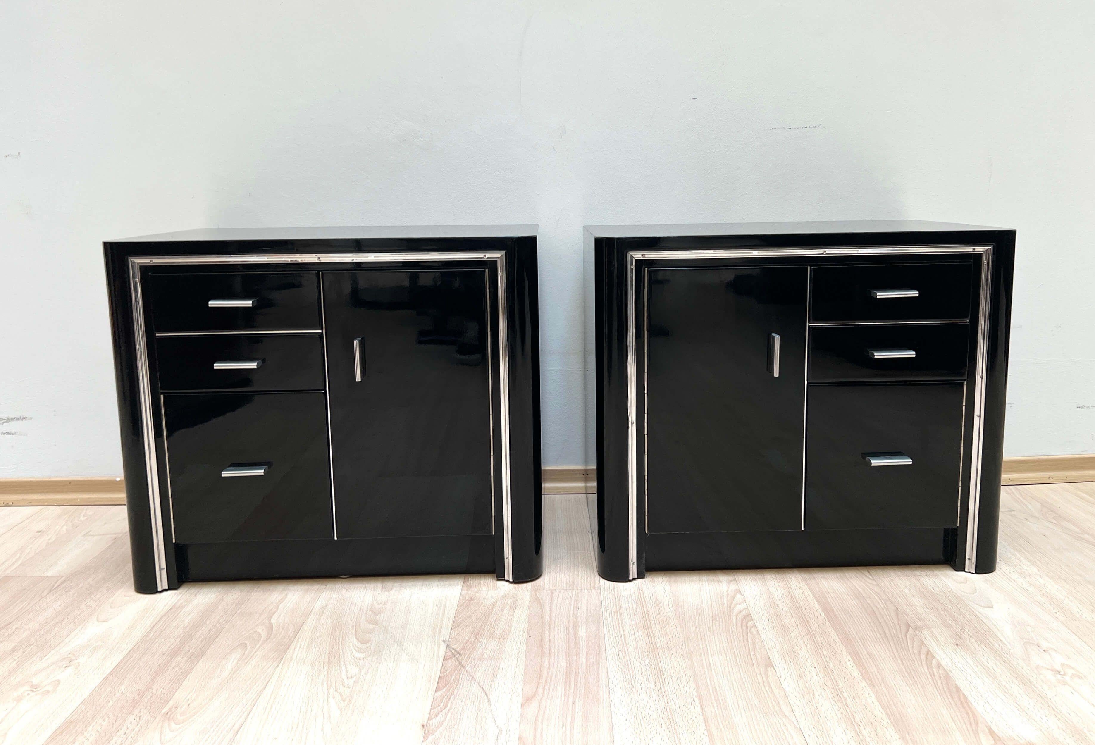 Pair of original Art Deco nightstands in black lacquer and metal.

Each with 2 drawers and 2 doors. Black high gloss lacquer. Brushed stainless steel handles. Aluminum trim. Mahogany and maple interior.

Dimensions: H 50 x W 59 x D 38/40.