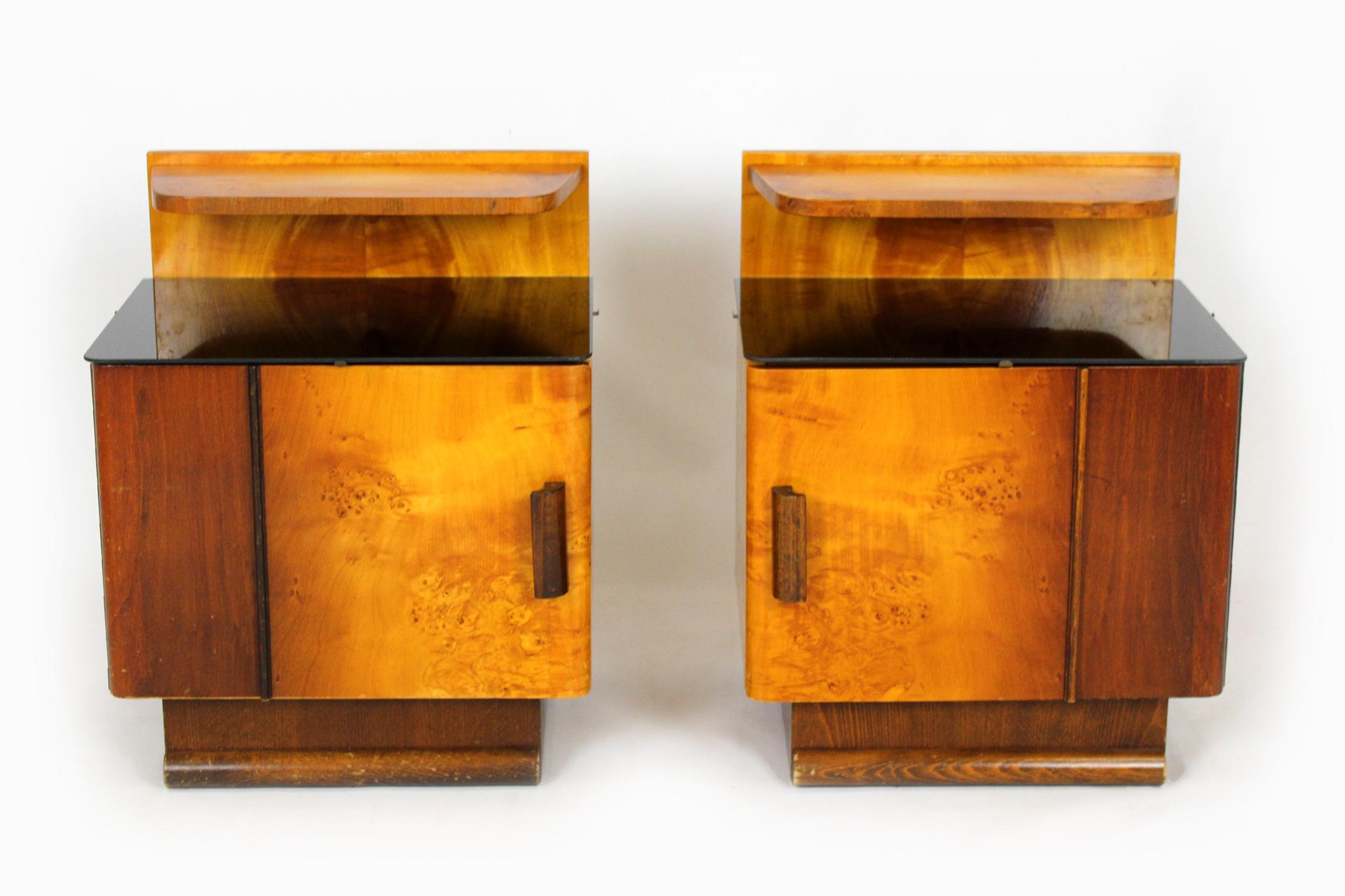 A pair of bedside tables produced in Czechoslovakia in the 1950s.
The cabinets are in their original, good condition. The glass on the countertops is new.