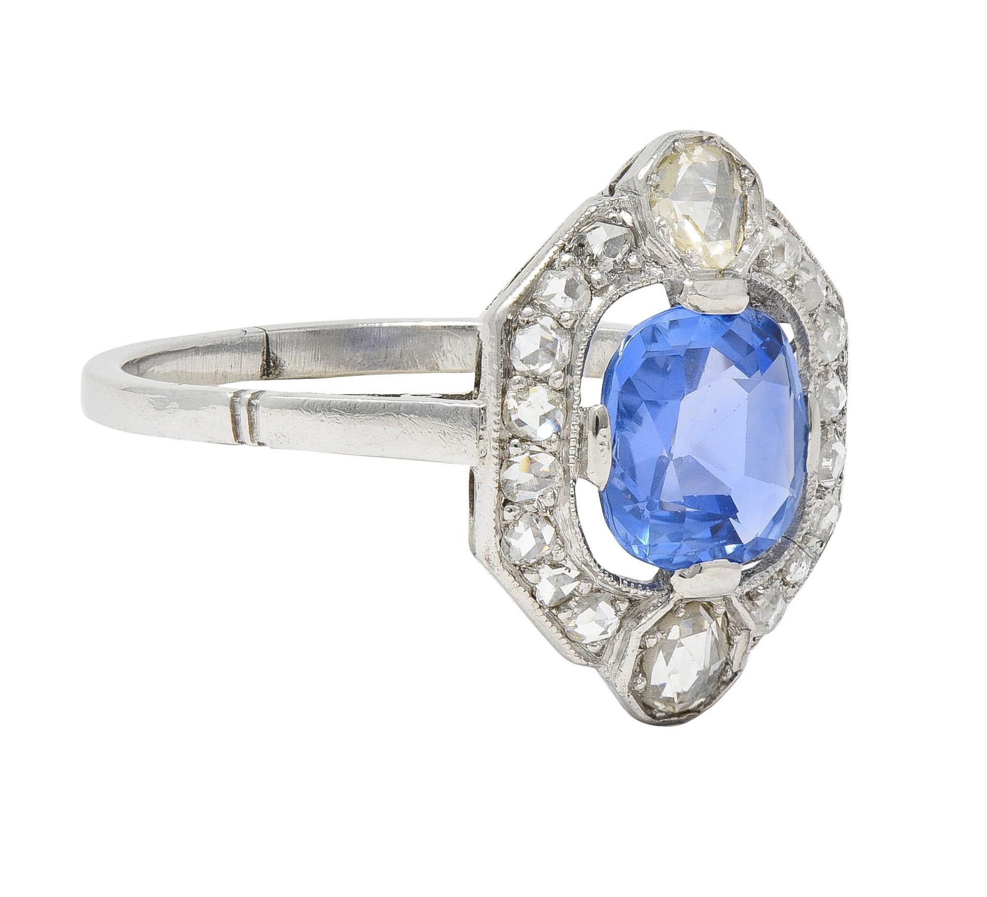 Centering a cushion cut sapphire weighing 1.72 carats total - transparent medium-light blue 
Natural Ceylon in origin and displaying no indications of heat treatment
Set with wide prongs with a pierced floating halo surround
Bead set with rose cut