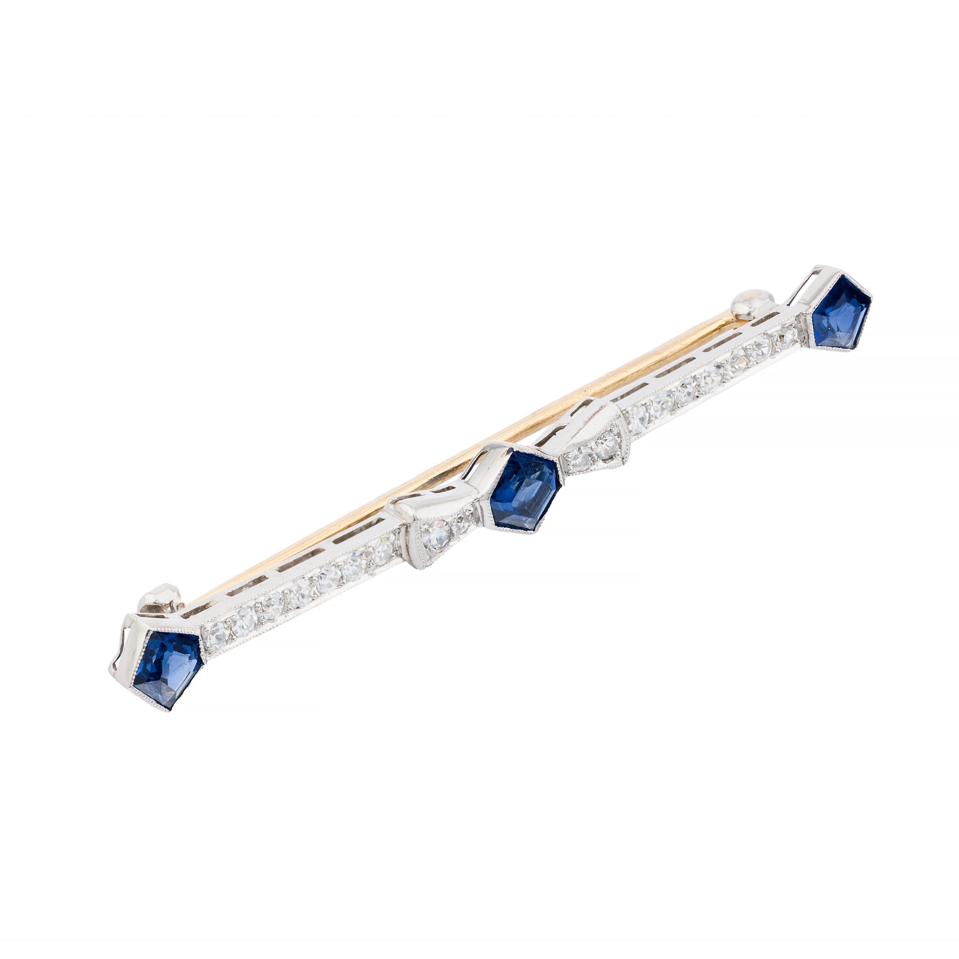 Aston Estate Jewelry Presents:

A refined Art Deco brooch from 1920, exemplifying geometric elegance and precision.

The design showcases mixed-cut blue sapphires, totaling 1.60 carats, set in a linear arrangement. Interspersed are round-cut