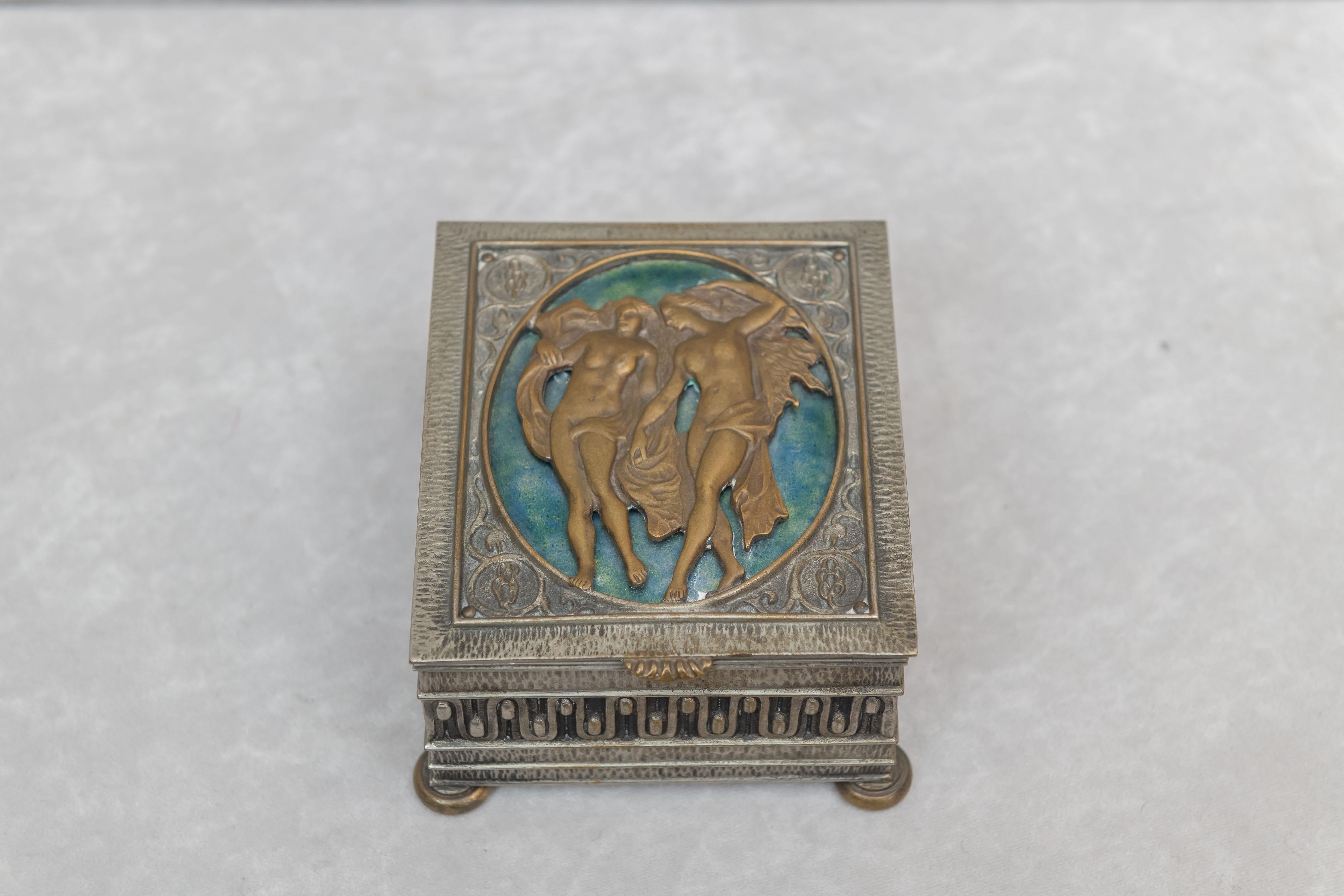 We are always on the lookout for interesting boxes. We think we have just that right here. While Oscar Bach was primarily known for his Art Deco objects we couldn't help noticing the hair on the woman on the lid. They look a little more Art Nouveau,