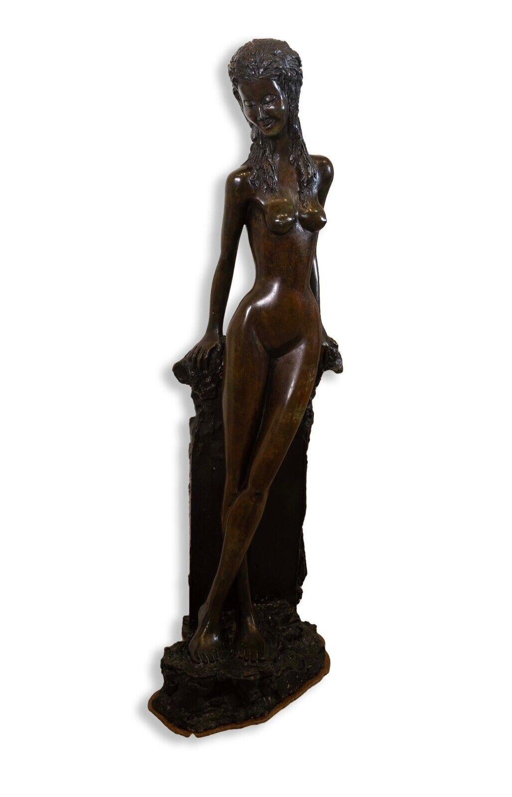 A lovely modern female nude bronze decorative figurative sculpture. Stylized in an Art Deco or Art Nouveau style. Artist unknown. A romantic and timeless composition. From a private collection. Dimensions: 39.5”h x 15”w x 11”d. In very good
