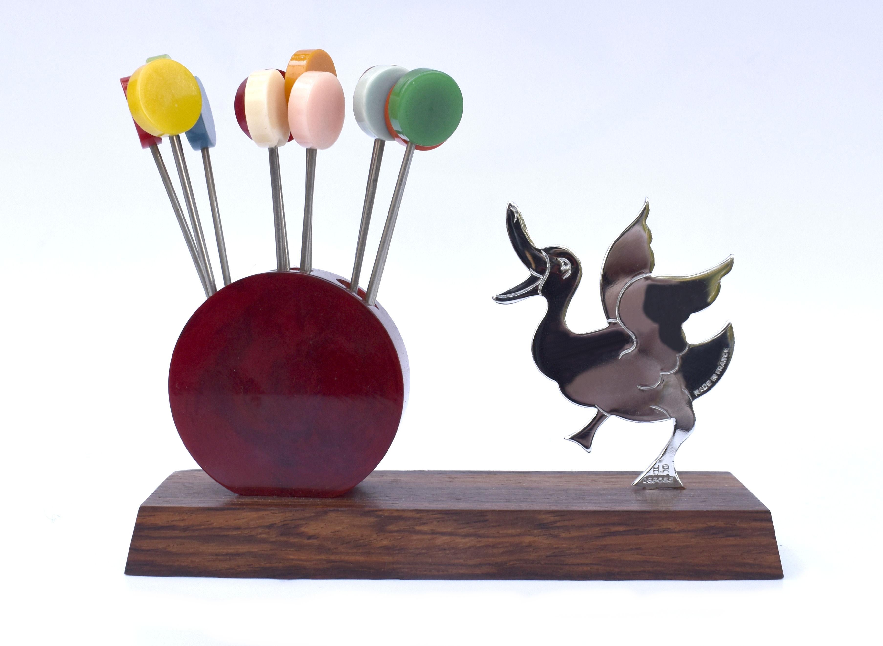 A novelty Art Deco circa 1930's cocktail stick set in the manner of a duck in a mid movement pose, made and originates from France. Features multi coloured Bakelite cocktail sticks with chromed metal prongs, all contained within a catalin bakelite