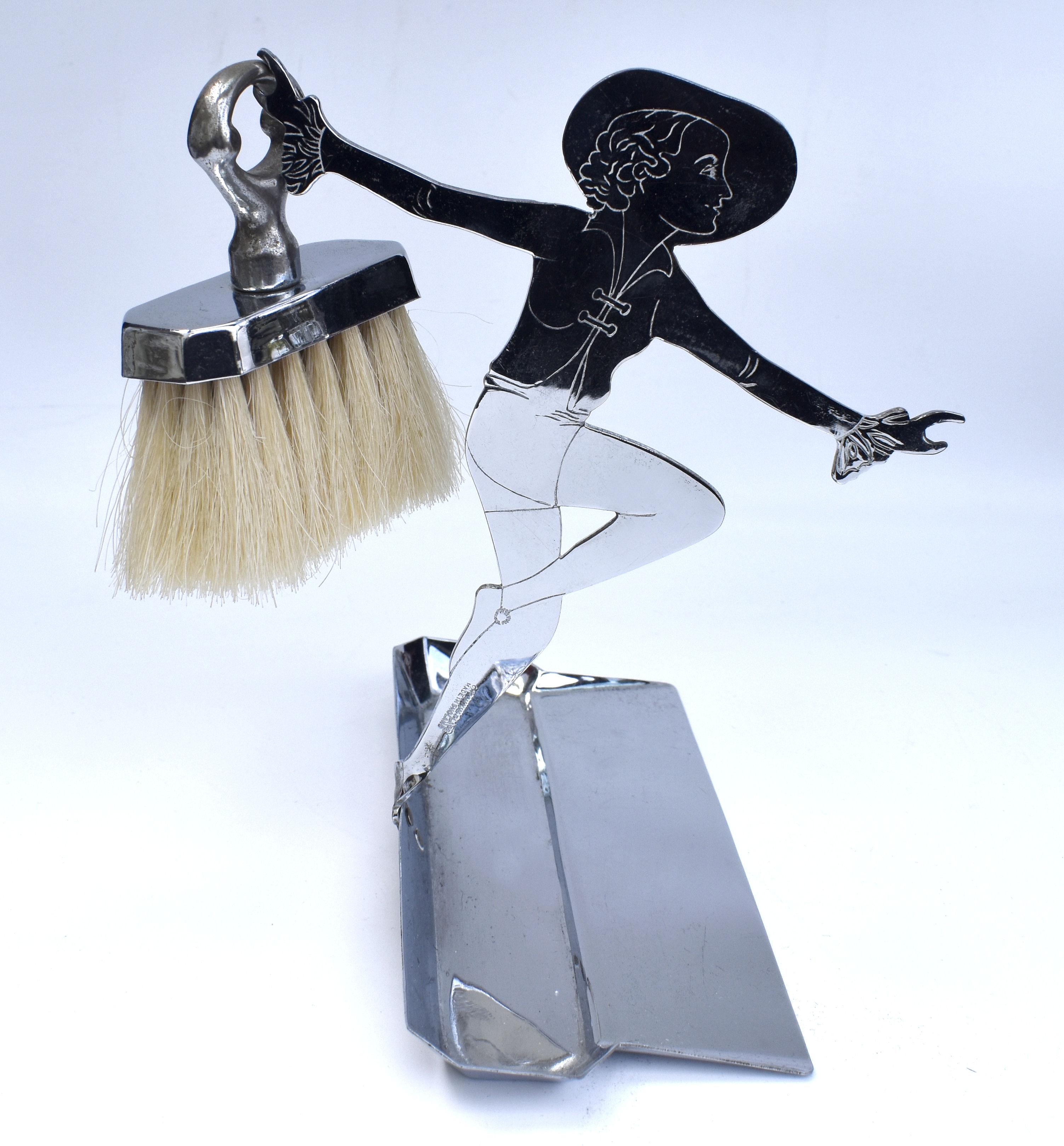 For your consideration is this charming novelty Art Deco chrome Brush and Crumb set. This dust pan is a stand that holds the brush with a ship handle. Features a two dimensional female in the fashion of the day holding a brush and supporting the