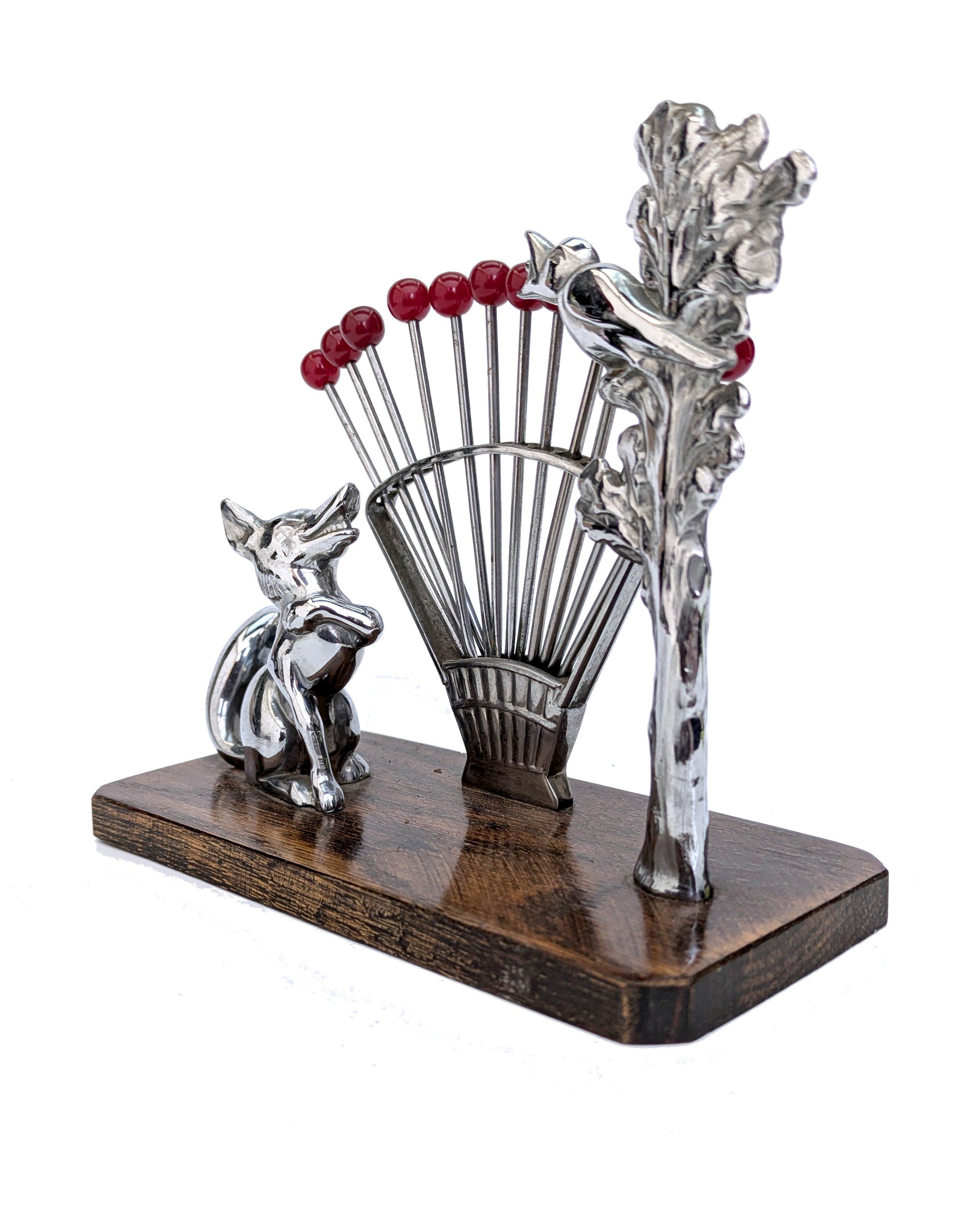 Original French wonderful novelty cocktail stick set. Features 6 chrome picks with cherry red bakelite handles. There are twelve in total creating a radial effect. 
The stand is walnut base with a chrome dig and feame. These sets are very rare and