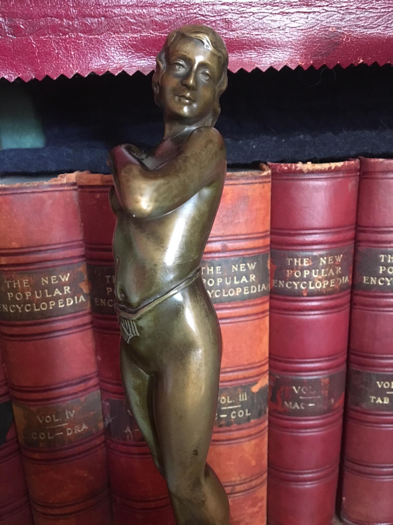 A most attractive Art Deco bronze figure of a nude, circa 1930s. Beautifully modeled and with an excellent patination to the bronze, it has a combined height of 12. 25 ins 31 cm. the alabaster base being 5 ins. 12.75 cm diameter and standing 2.5 ins