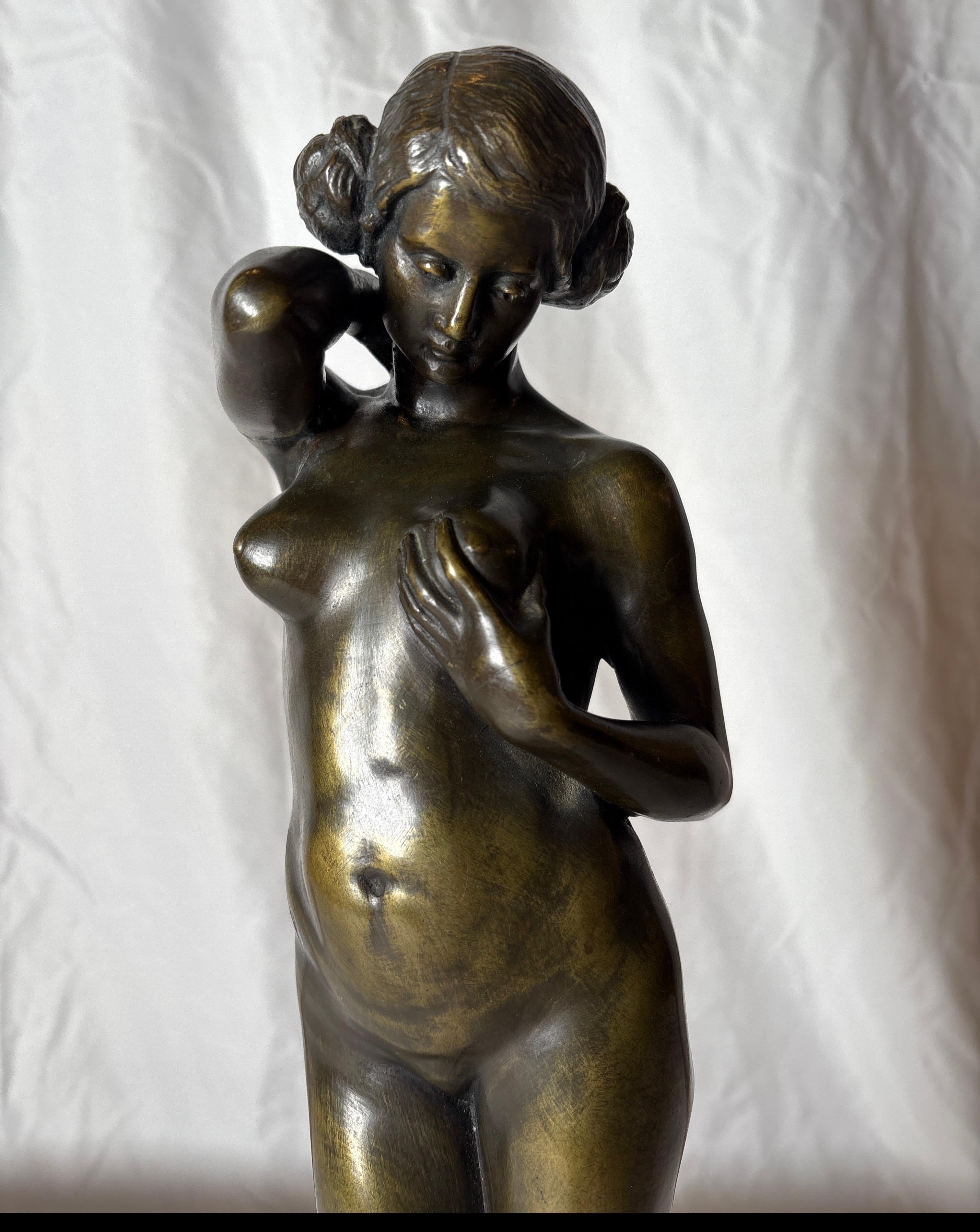 A fine bronze of a nude woman on rouge marble base.  It has a nice verde patina and is well-detailed.