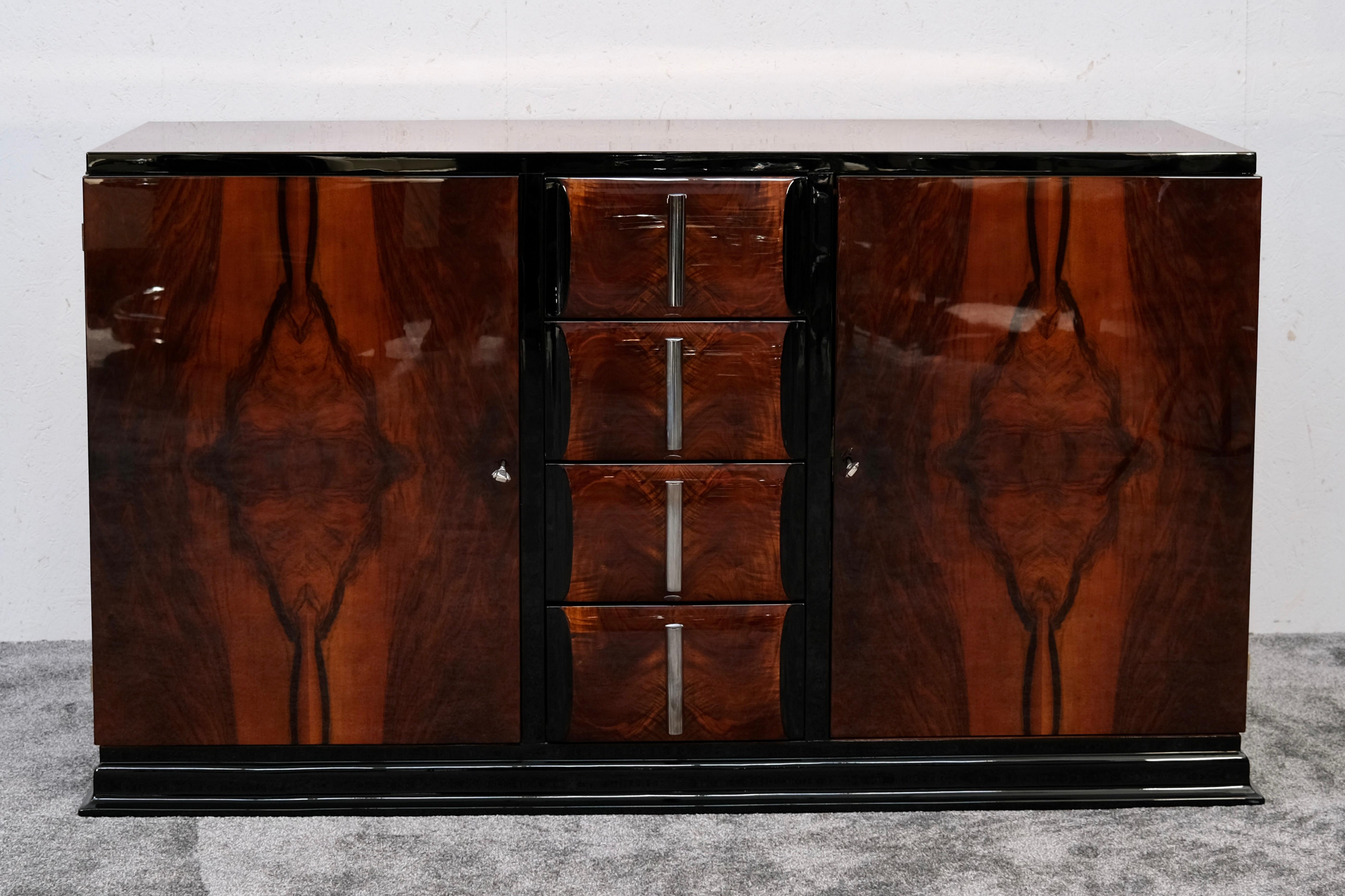 This striking Art Deco sideboard evokes the glamour and precision of the 1930s – a statement piece for those who appreciate both elegance and craftsmanship. The front is clad in highly figured walnut veneer, polished to a high gloss that intensifies