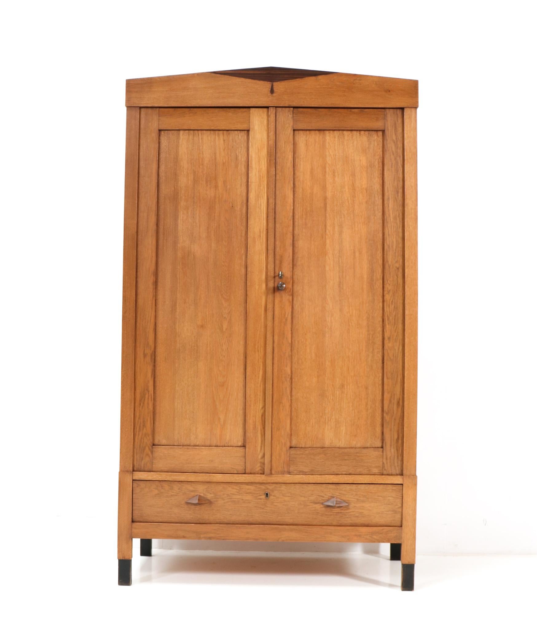 Stunning and rare Art Deco Amsterdamse School armoire or wardrobe.
Striking Dutch design from the 1920s.
Solid oak and oak triplex with original solid macassar ebony knob on the 
right door.
The drawer has also two original solid macassar ebony