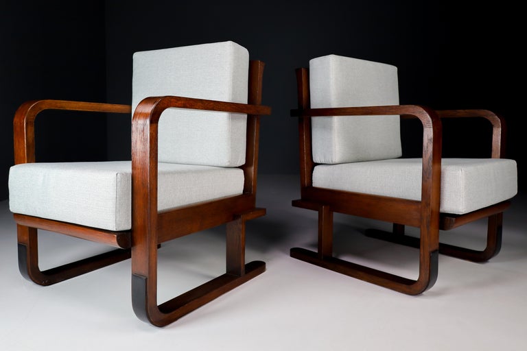 Pair of two Art-Deco lounge / arm chairs, in Oak and Re-upholstered fabric, France, 1930s. These armchairs would make an eye-catching addition to any interior such as living room, family room, screening room or even in the office. It also perfectly