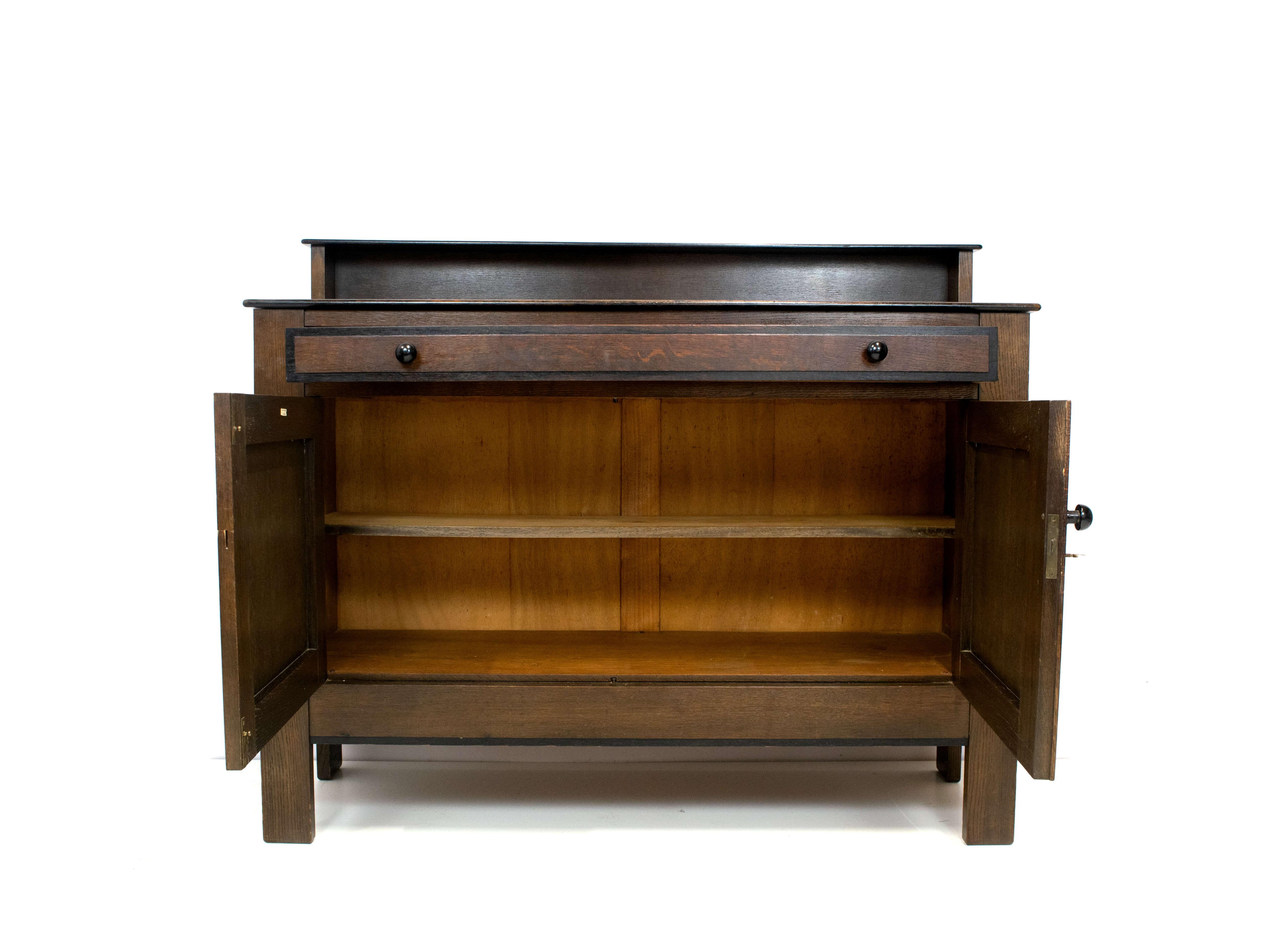 Stunning Art Deco, The Hague School, oak cabinet by J.A. Muntendam for L.O.V. Oosterbeek, Netherlands, 1924. This cabinet is made of oak inlaid with ebony. It has a beautifully understated and calm appearance. Underneath the drawer there are two