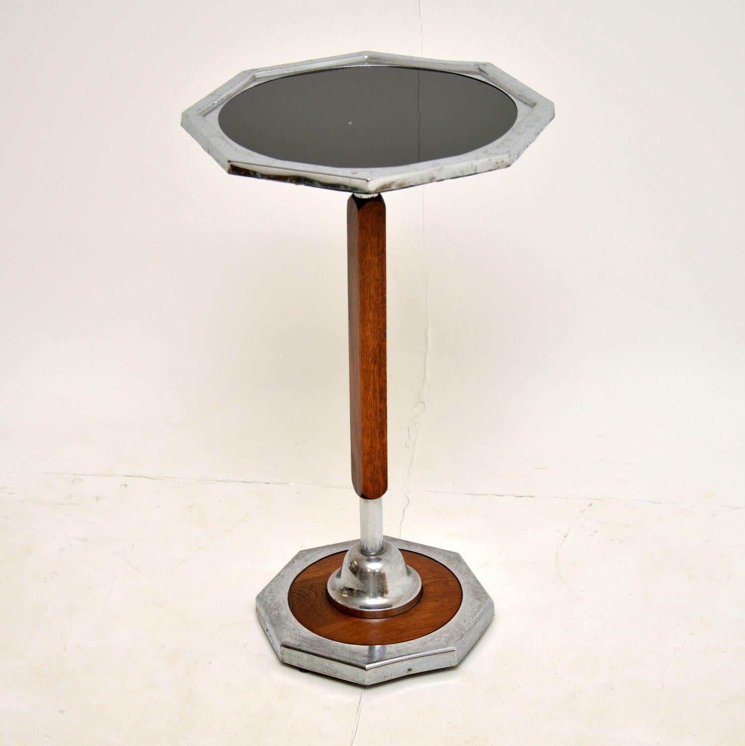 A stylish and rare original vintage Art Deco period side table in oak and chrome. This was made in England, it dates from around the 1930’s.

The inset black top is black mirrored glass, which has some minor surface wear and wear to the backing.