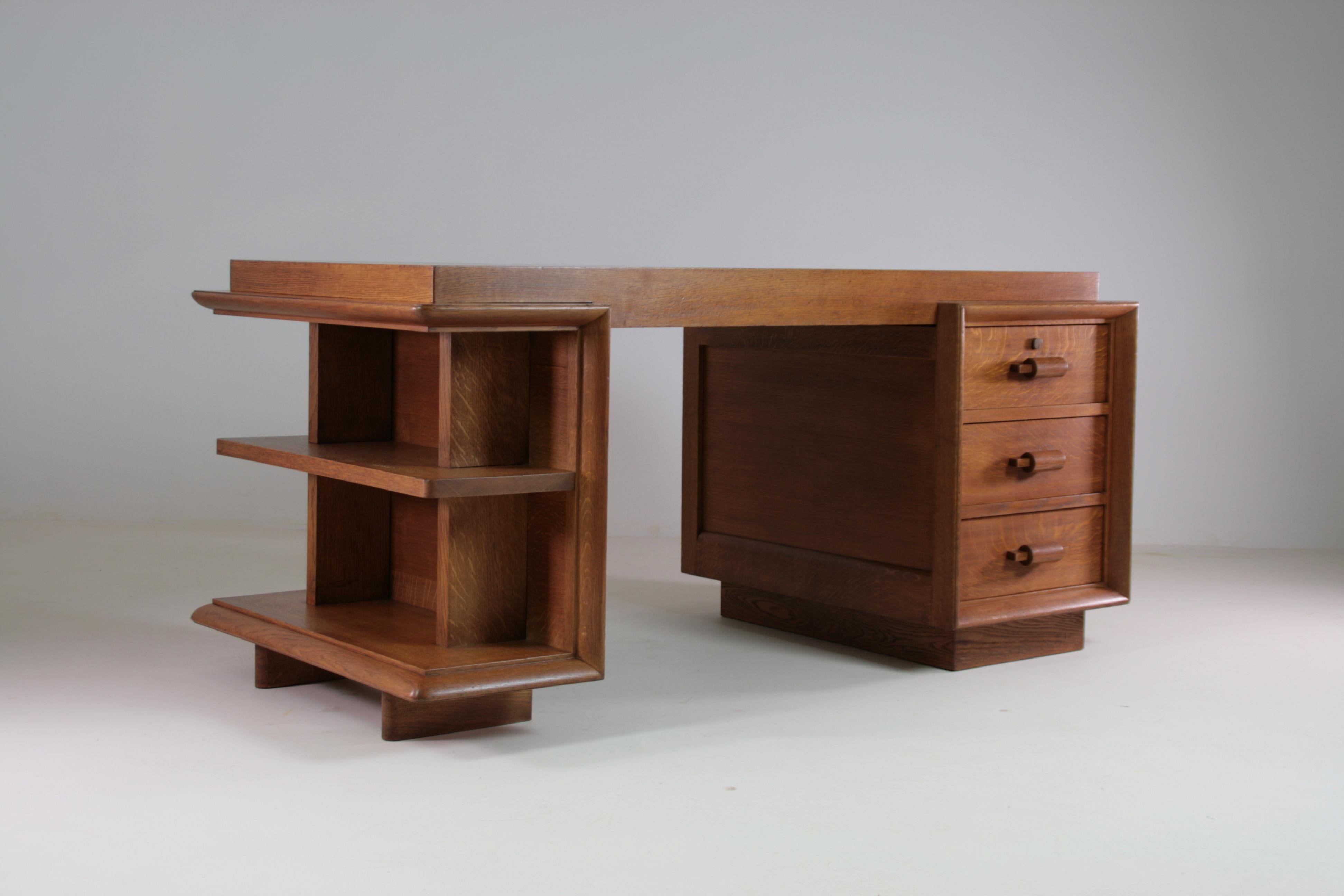 Dieser Art-Déco-Schreibtisch aus Eiche, entworfen vom französischen Designer Charles Dudouyt, verkörpert die Eleganz der Art-Déco-Bewegung der 1940er Jahre. Er ist aus massiver Eiche gefertigt und zeichnet sich durch eine solide Konstruktion und