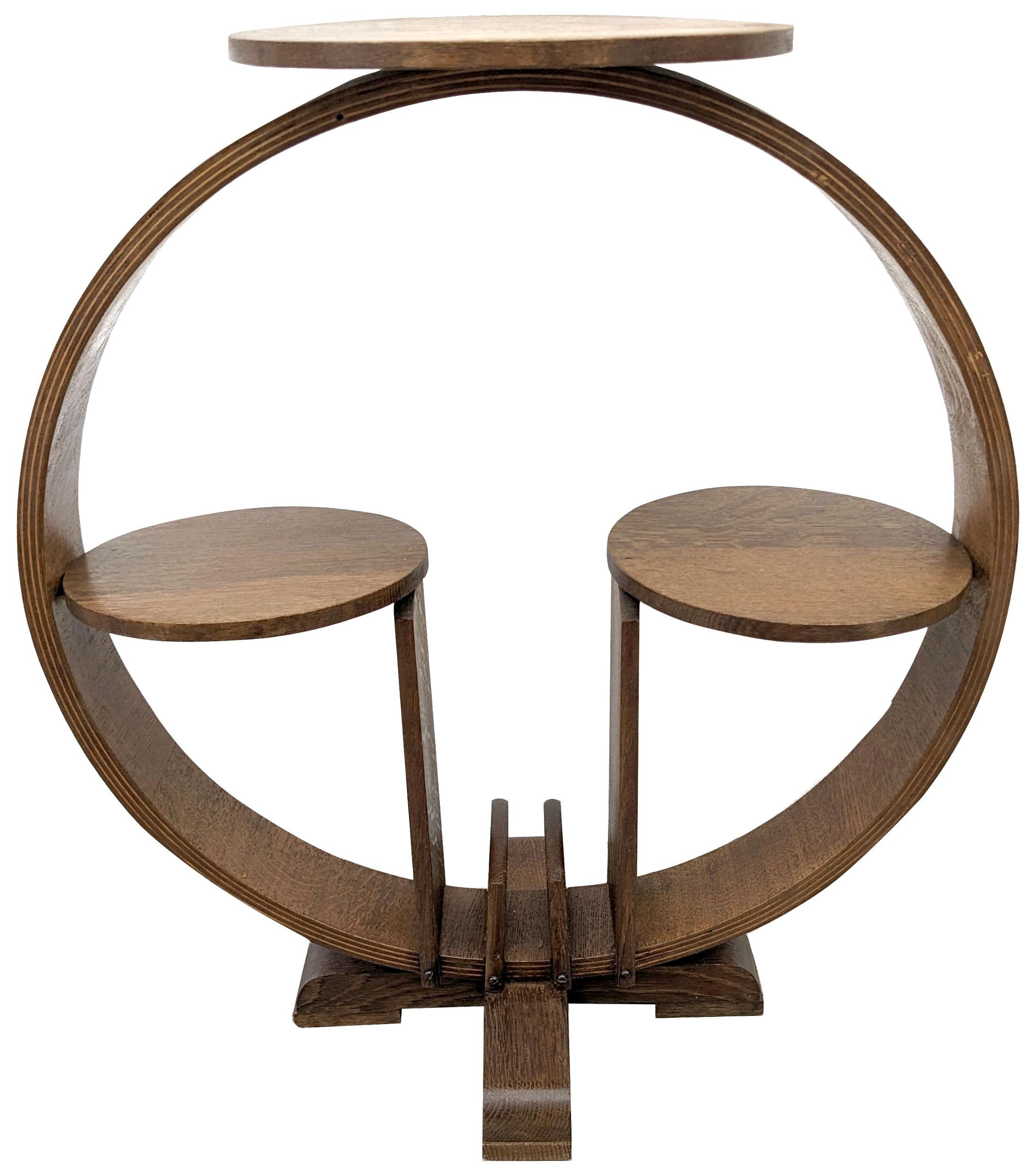 For your consideration is this superbly styled Art Deco stand, made from blonde oak and originates from England. Quite a good size standing 65 cm in height. Features three circles held within a large circular frame. To the base is an area to place