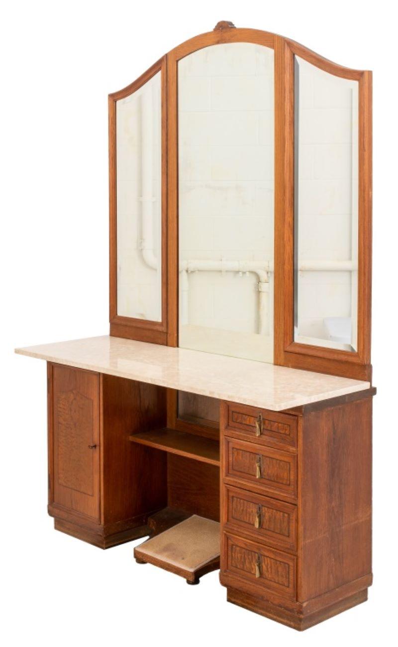 Art Deco oak dressing vanity with a stationary central beveled mirror flanked by swing beveled mirrors, one door with marquetry to left side and four drawers with gilt metal handles to right side, modern quartz top, circa 1940s. Measures: 77
