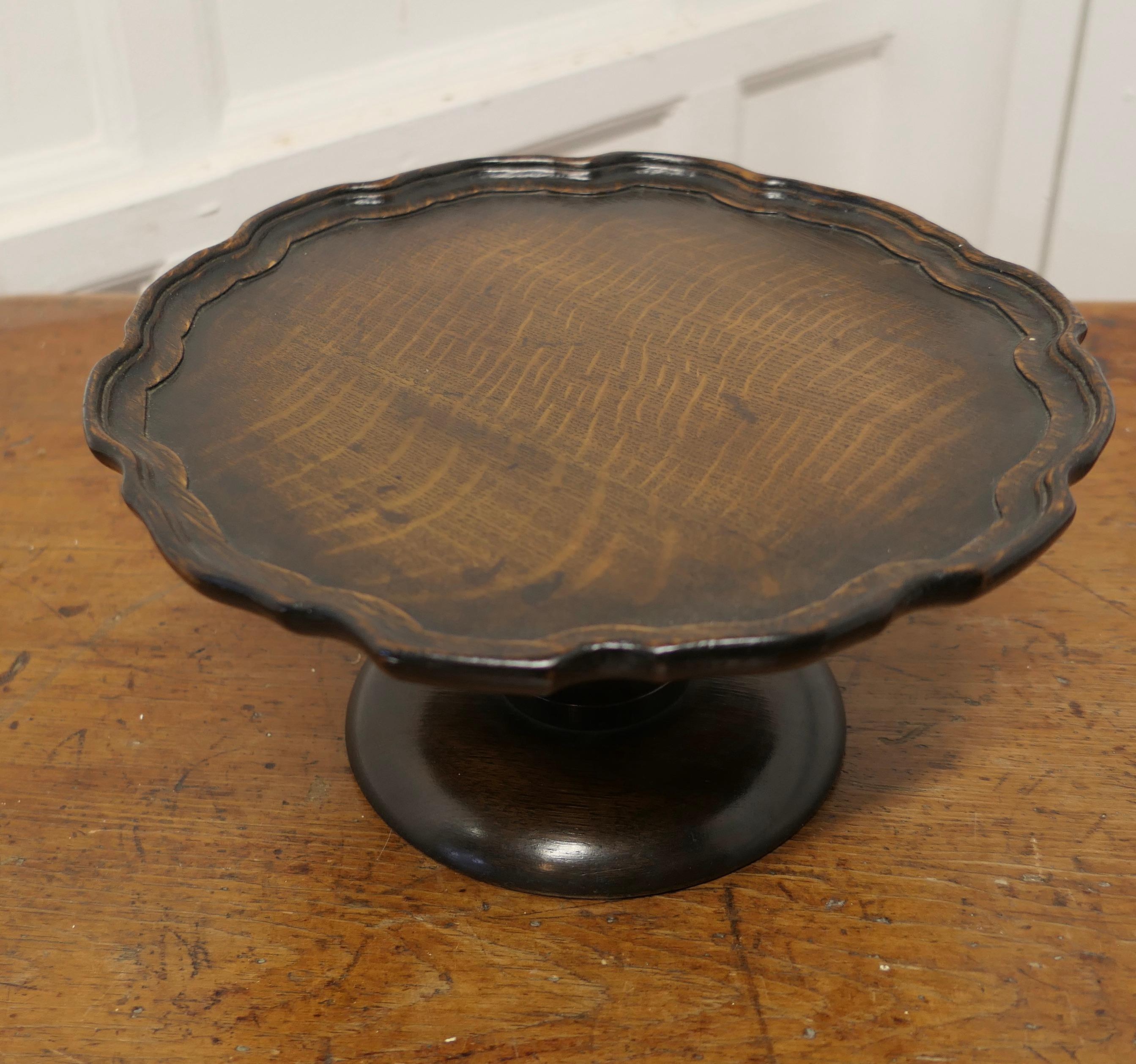 Art Deco Oak Lazy Susan Tazza

A very useful piece, a revolving platter with a beautifully carved pie crust edge. The centre column is sturdy giving a very smooth spin when in use
The Stand is 6” tall and 12” in diameter
SW167