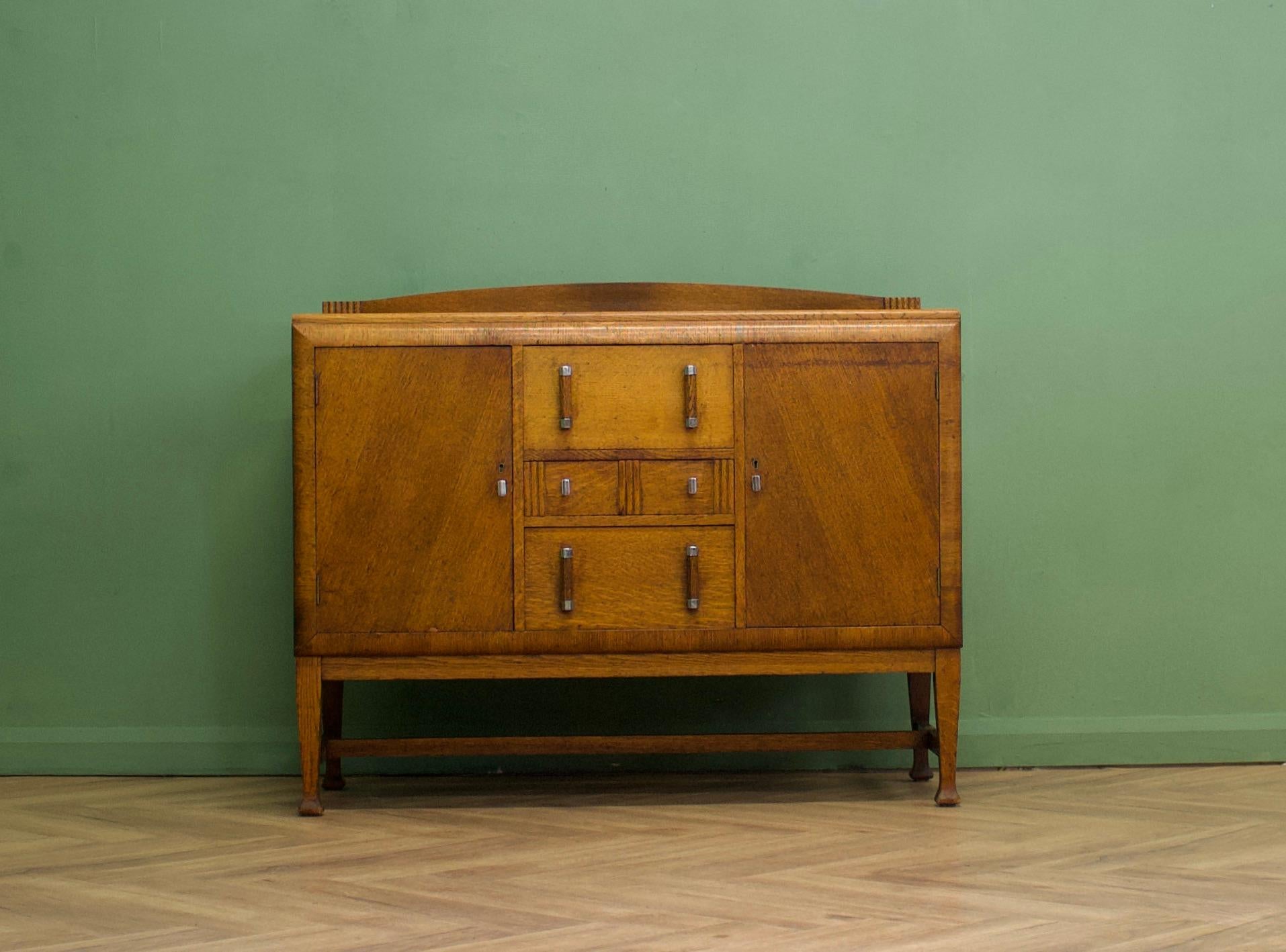 A high quality, dark oak Art Deco sideboard, circa 1930's-1940s
This piece is heavy and sturdy 
 
Featuring two drawers and two cupboards with shelves

