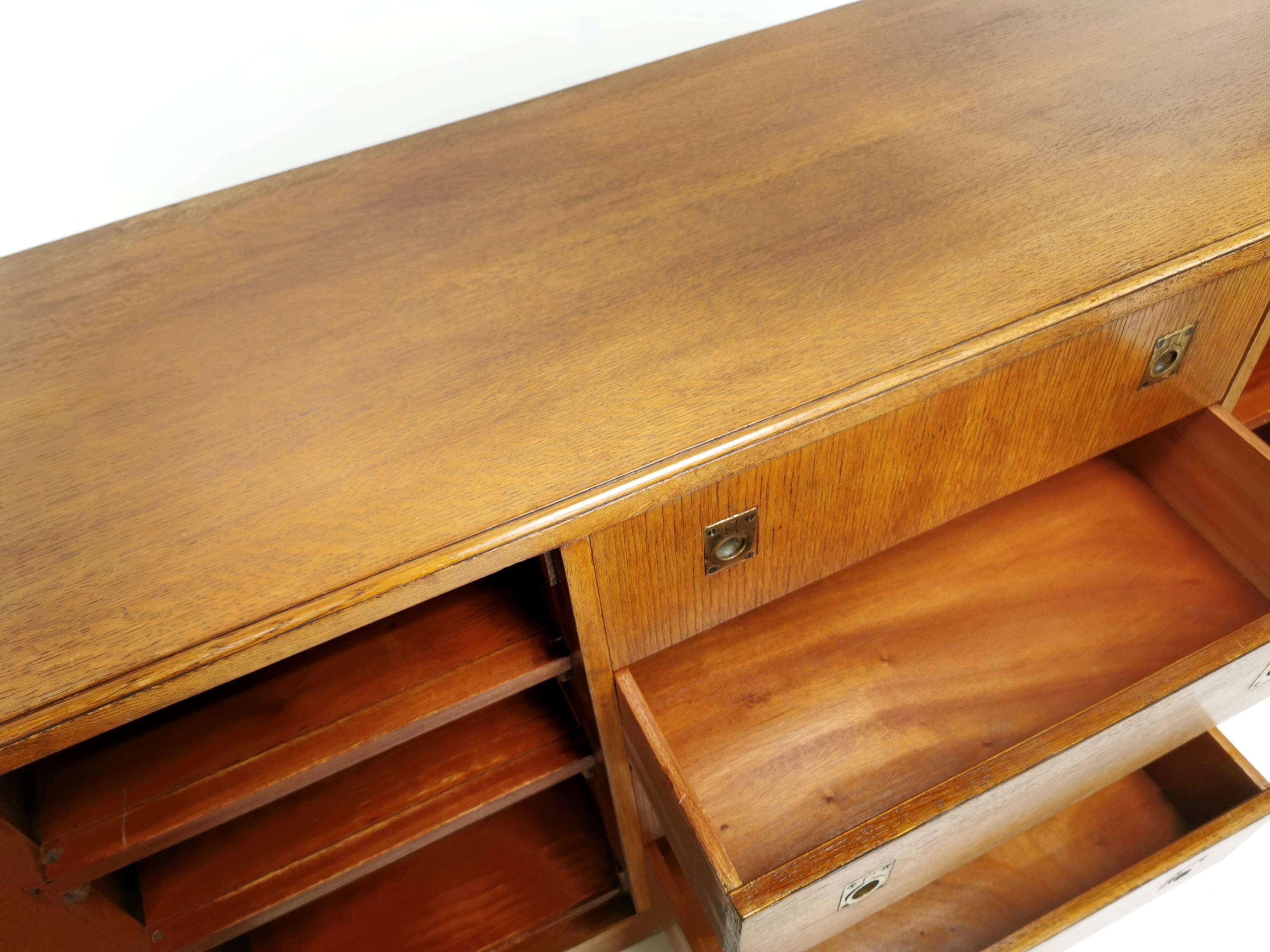 Art Deco sideboard 

An Art Deco oak sideboard in the manner of Heal's, with central drawers flanked by panelled cupboards.

Featuring military campaign style drawer pulls. 

British, circa 1930s.

Dimensions (cm): 

W 137 x H 75 x D