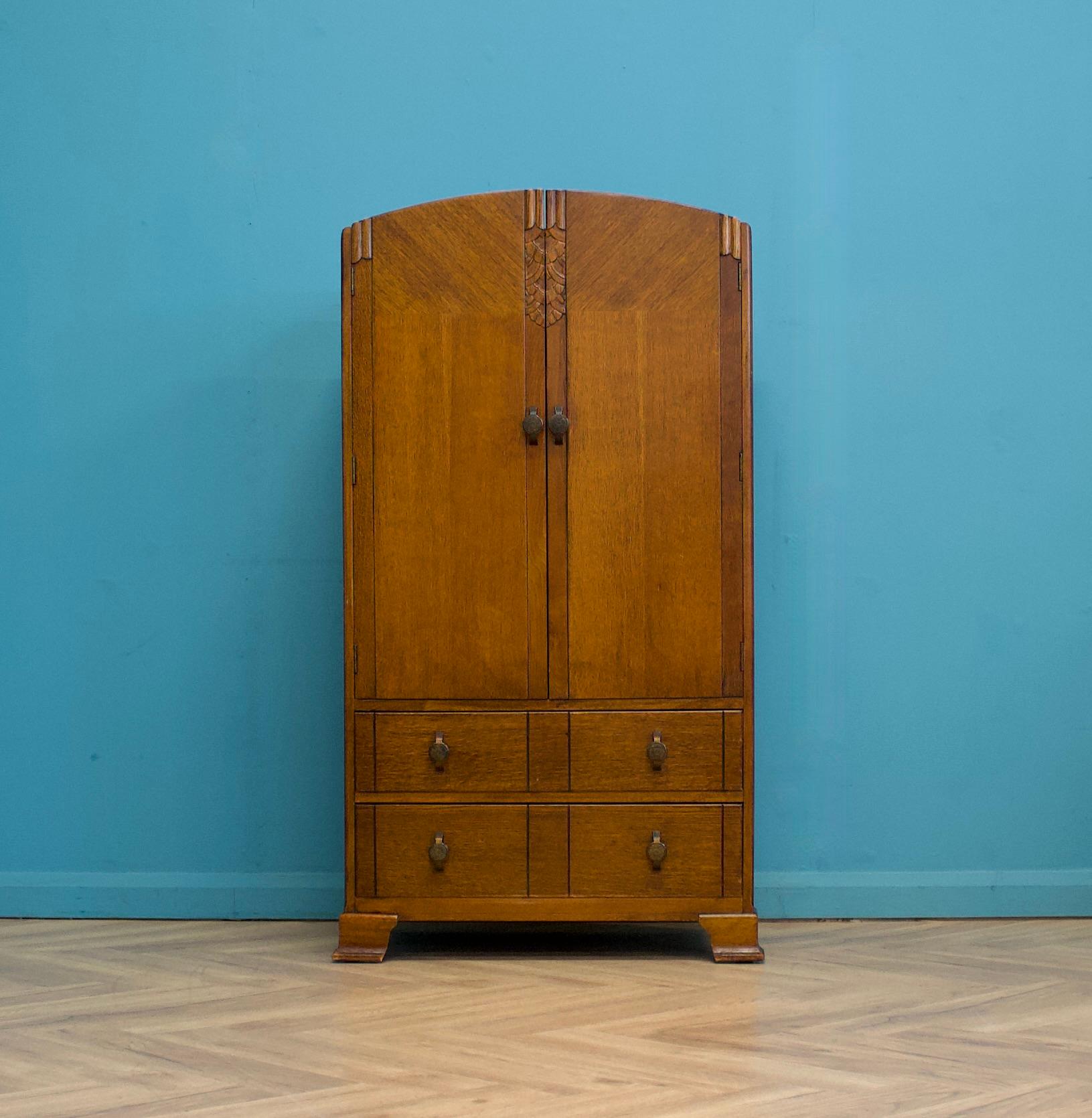 An impressive quality Art Deco oak tallboy or housekeeper’s cupboard, circa 1930s
Made by Harris Lebus for Utility Furniture.


The inside the cupboard are shelves and a further three drawers to the bottom.