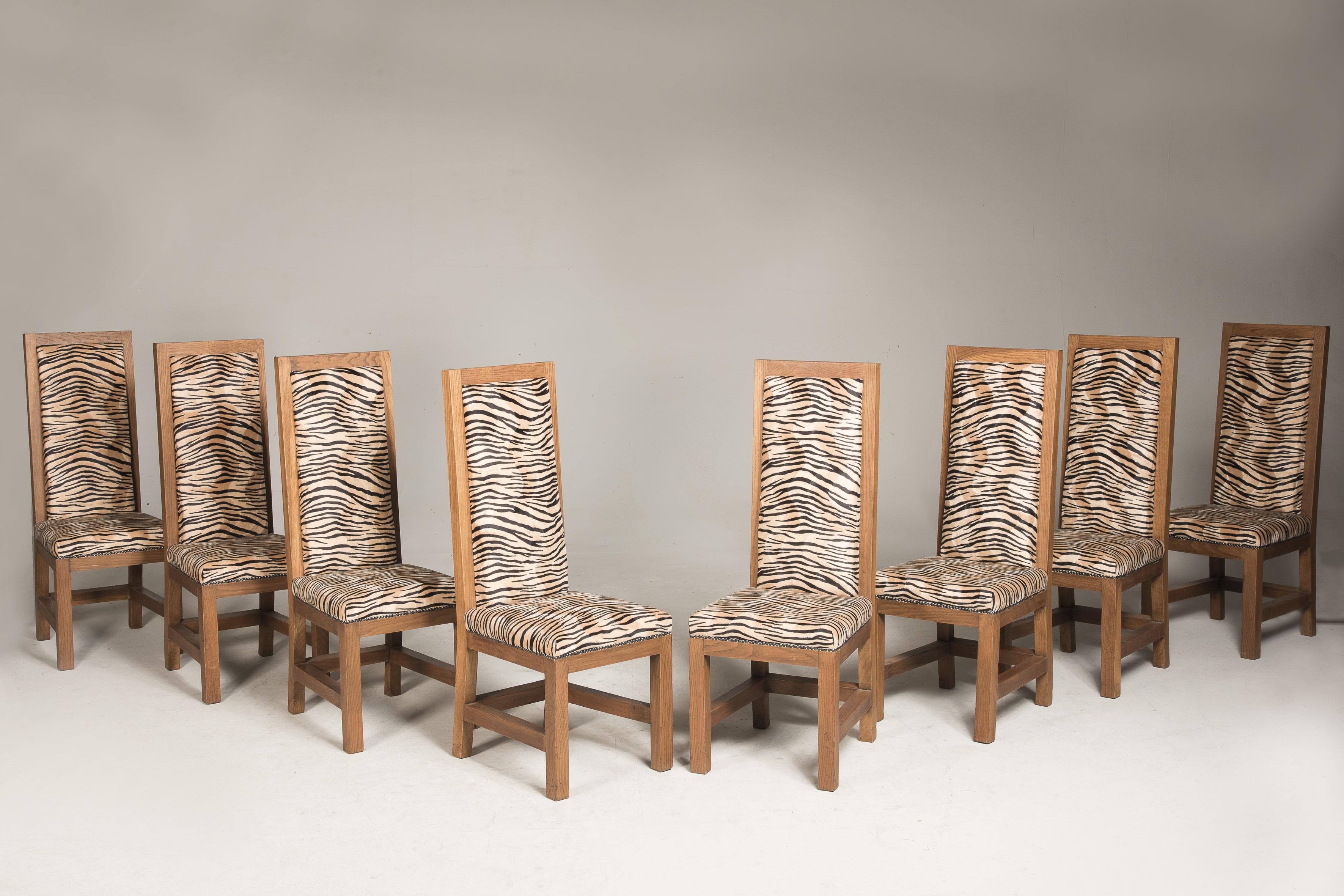 Set of eight Art Deco oak chairs with original patina, wax finish, from France.
Recent tiger upholstery. 

