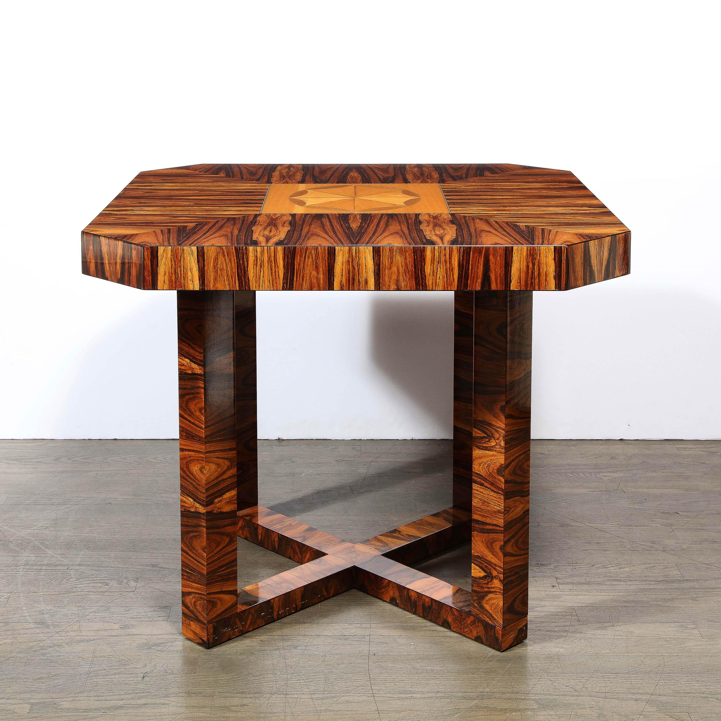 This sophisticated Art Deco table was realized in France circa 1930. It features an x form base with streamlined supports and an octagonal top (formed from a square with cut corners)- all in beautiful bookmatched zebrawood showcasing a dramatic