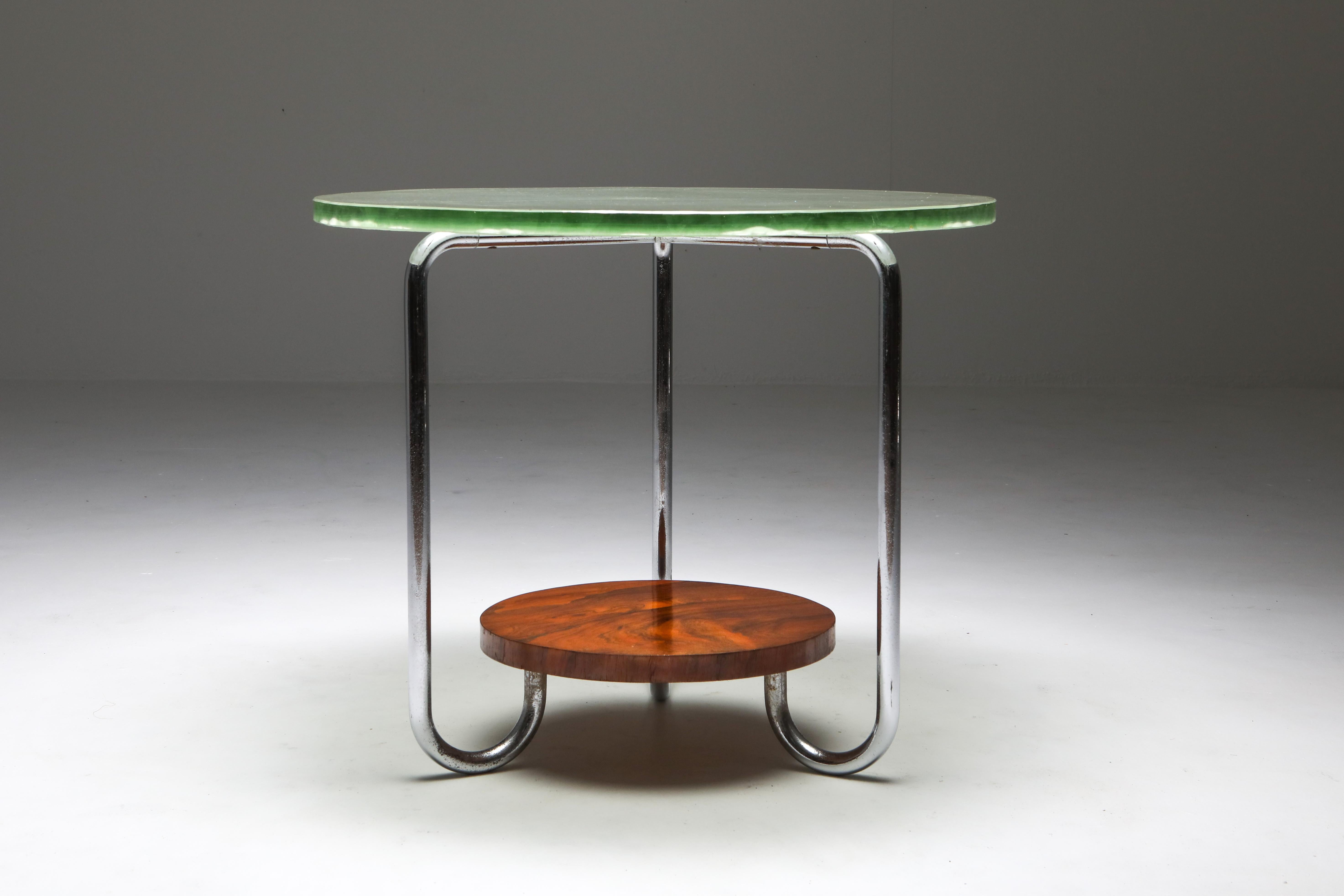 Unusual Art Deco occasional table, France, 1930s

Tubular chromed steel frame connects the rosewood tier with the thick glass top.
Remarkable glass top, very thick with organica etched carvings.
A spectacular piece.

  