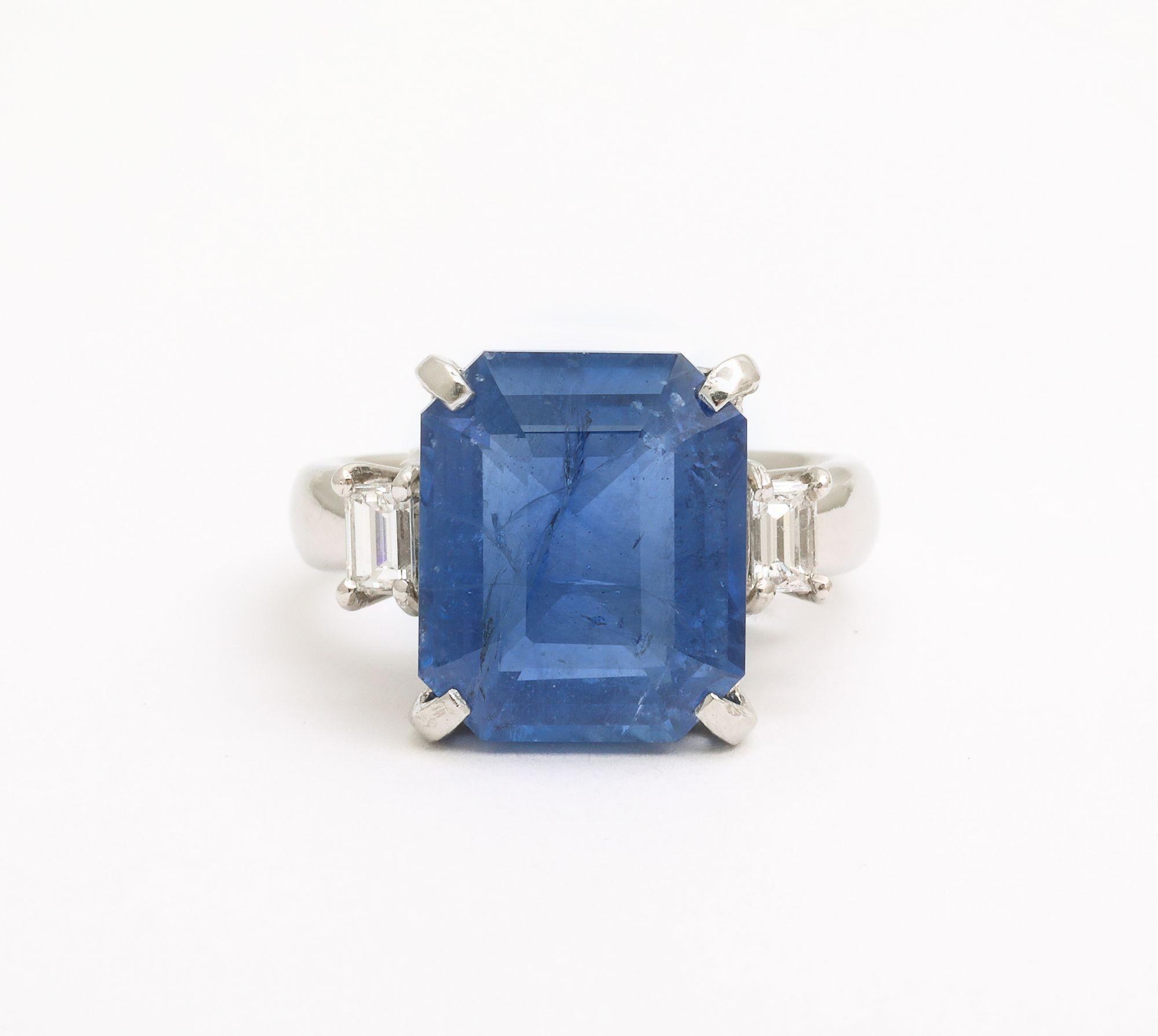 A fabulous Art Deco Octagonal 10 ct Ceylon Sapphire Engagement Ring with Diamond Baguettes. A natural Ceylon 10 ct octagonal cut with visible inclusions flanked by emerald cut diamonds on Platinum mount. Certificate available GIA Sapphire Origin