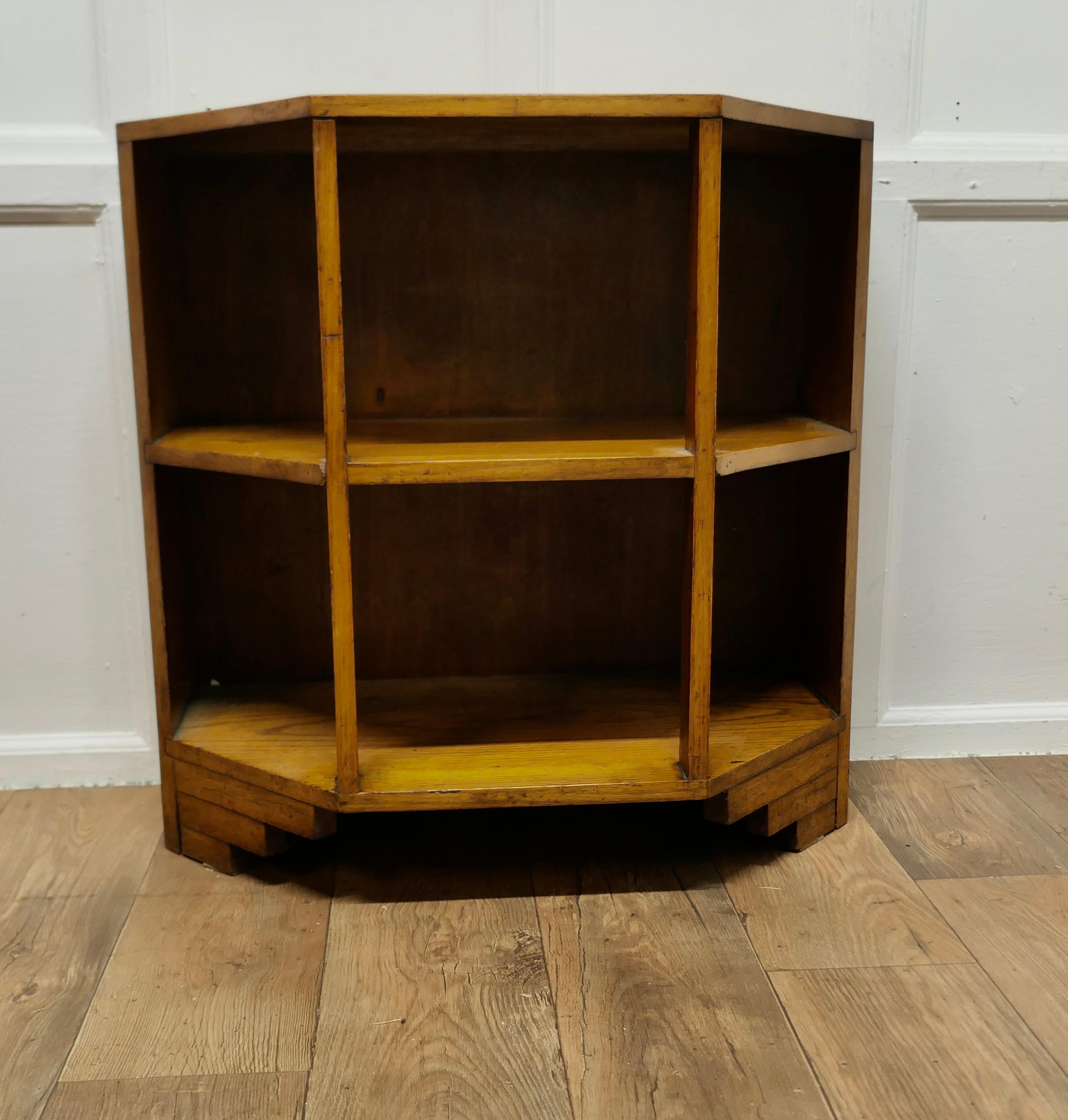 Art Deco Odeon Style Golden Oak Floor Standing Shelves

This is an excellent Heavy quality piece made in Golden Oak in the Art Deco style, note odeon style bracket feet 
The unit has a 3 sided shape to the front and a long shelf in the centre, a