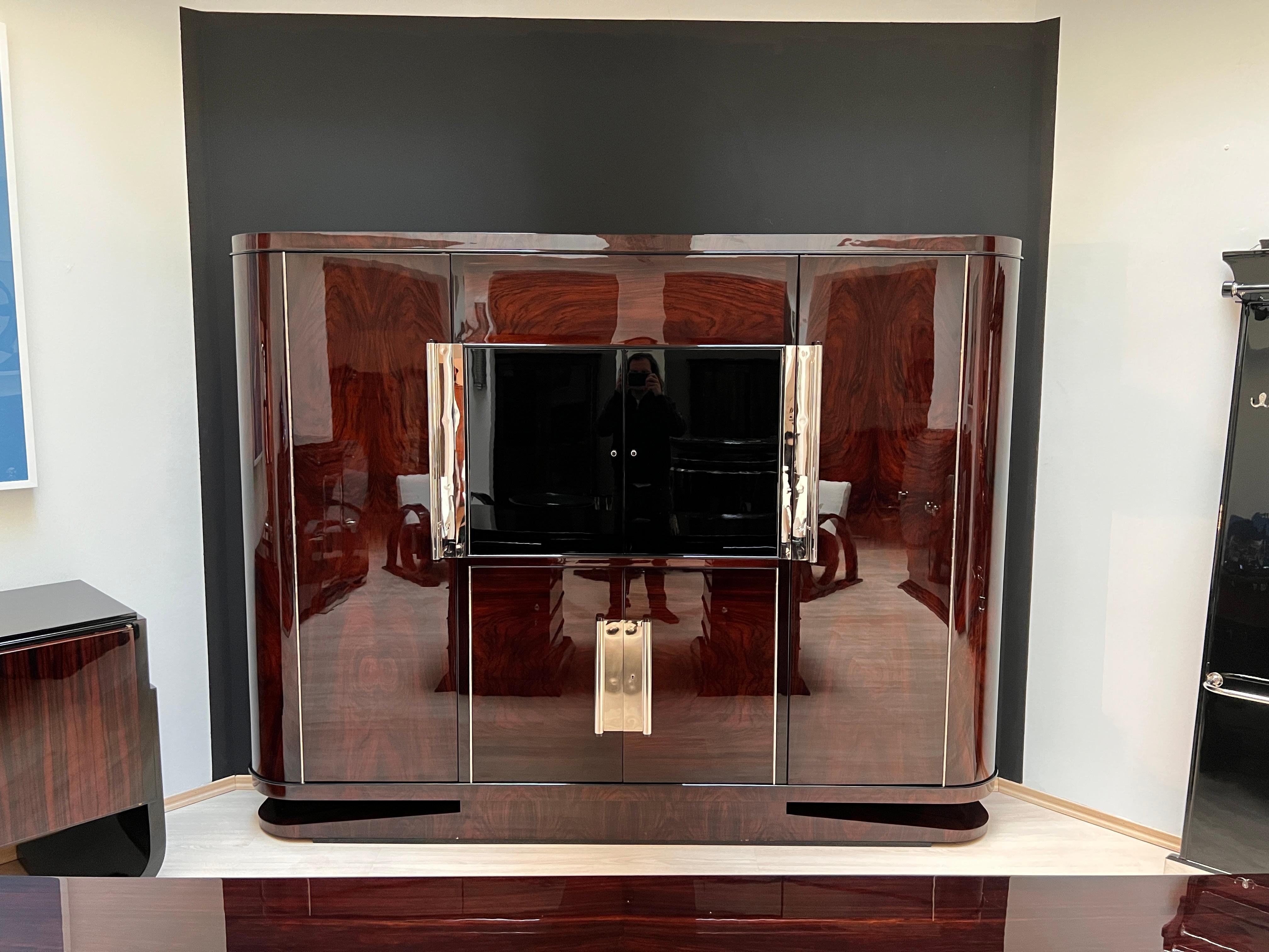 Large original Art Deco Executive Office Cabinet or Bookcase in Rosewood and black piano lacquer. 
Wonderful Rosewood (Palisander) veneer pattern and beautiful long original nickel-plated handles. 
Two rounded high doors in rosewood with adjustable